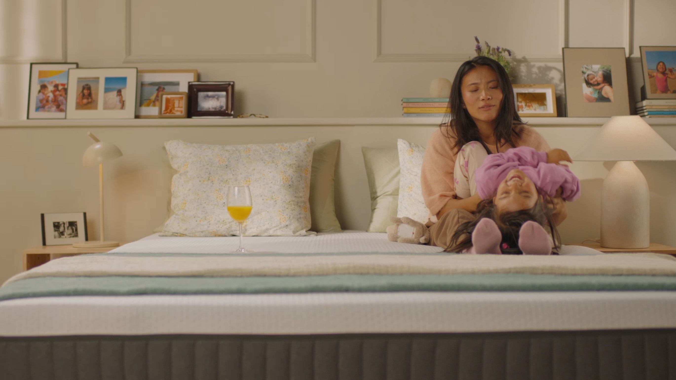 Person resting on a bed with a white mattress, showing undisturbed comfort.