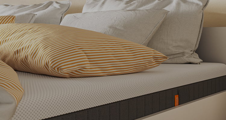 CLose up of a mattress with the orange Emma tag of it