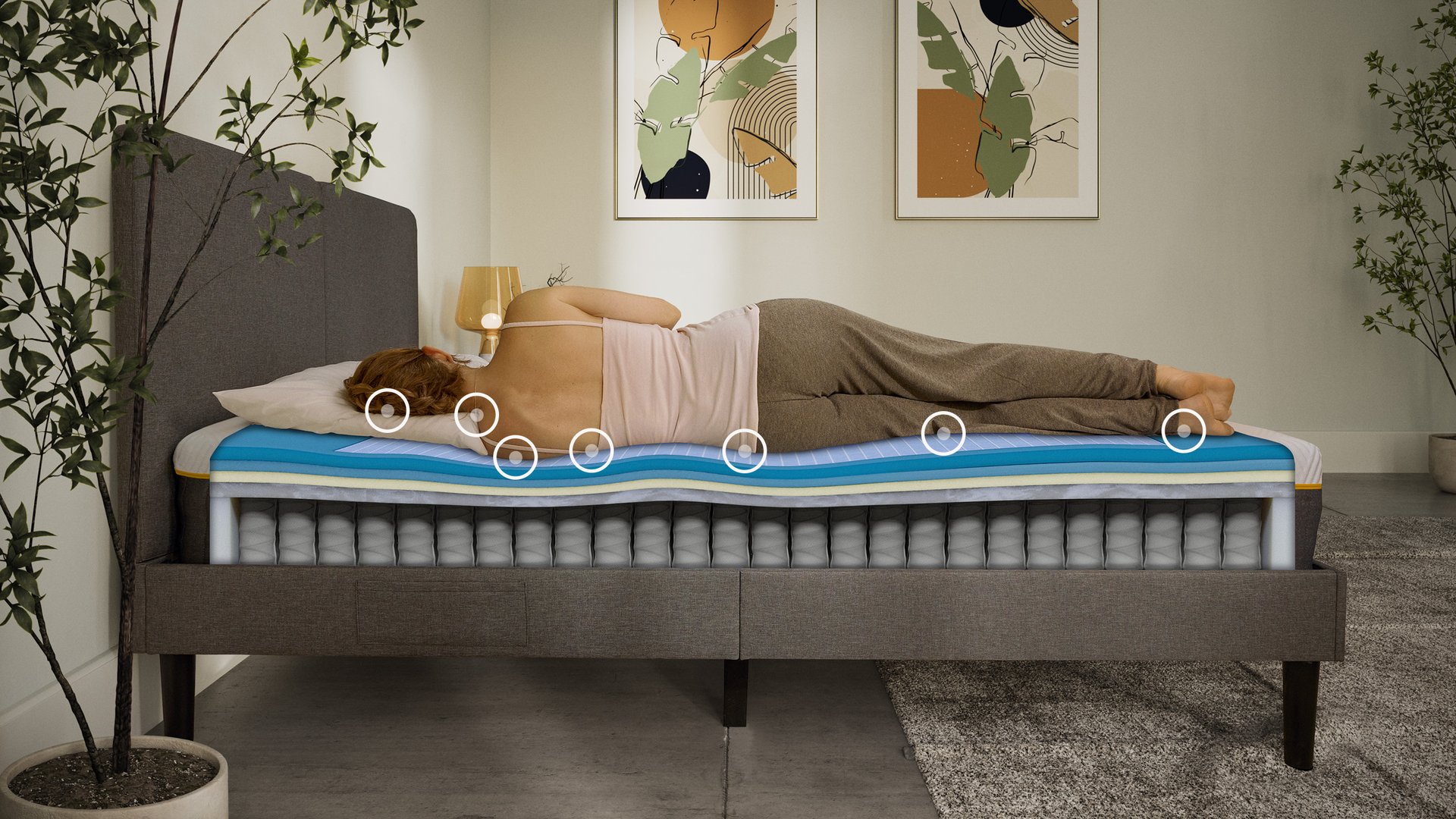 Woman sleeping on her side on an Emma Original Elite mattress with a layers view showing foam and spring construction beneath her.

