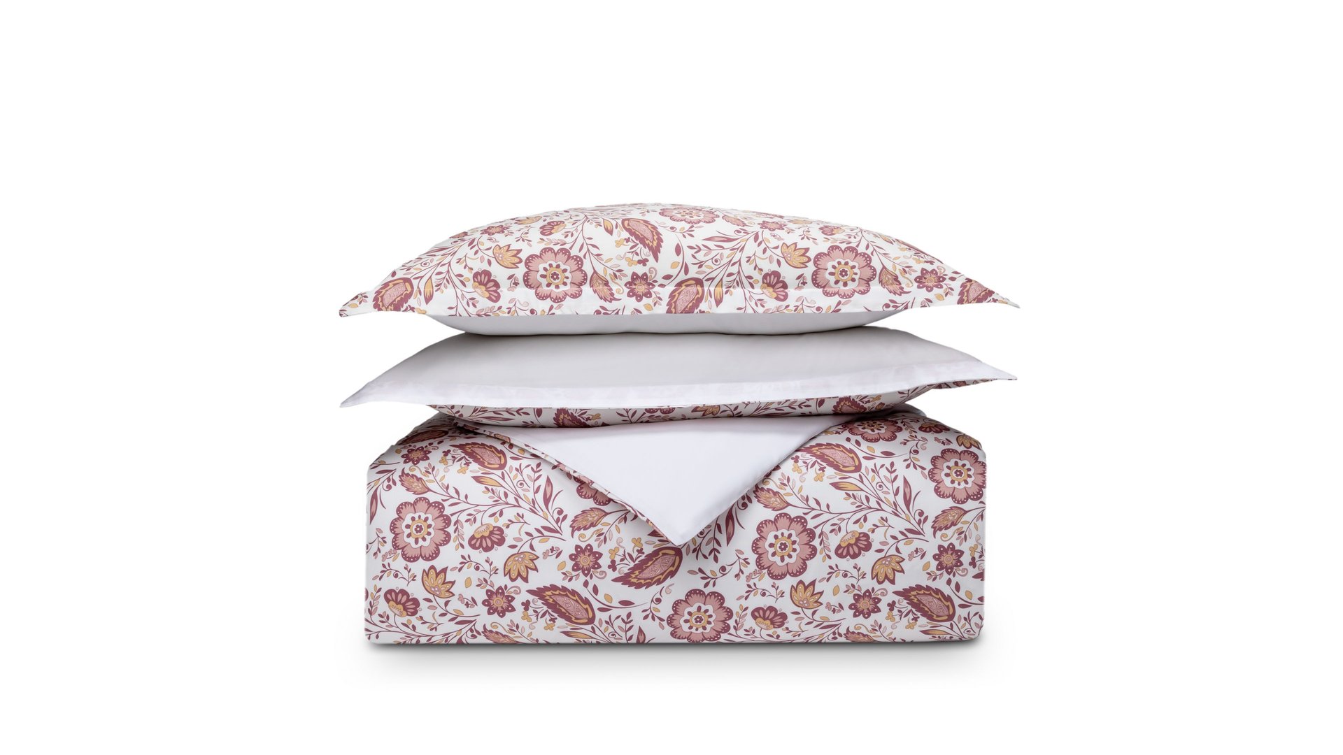Set di biancheria piegato con motivo floreale rosa e beige su sfondo bianco, cuscino sopra il piumone.