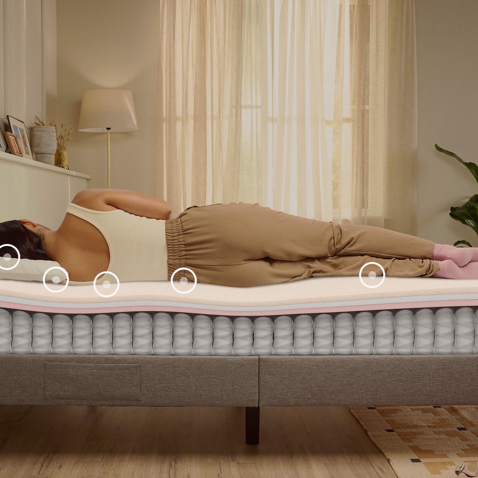 Person lying on their side on a white mattress in a relaxed sleeping position.