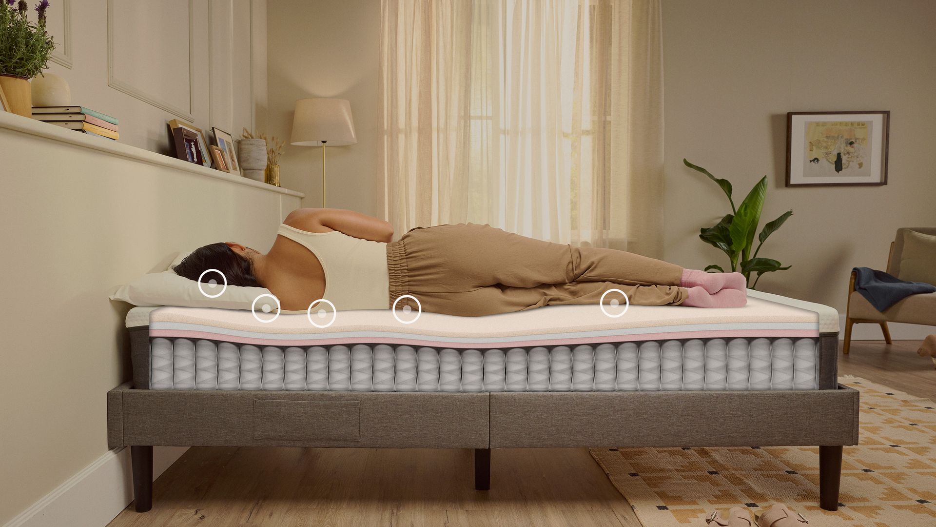 Person lying on their side on a white mattress in a relaxed sleeping position.
