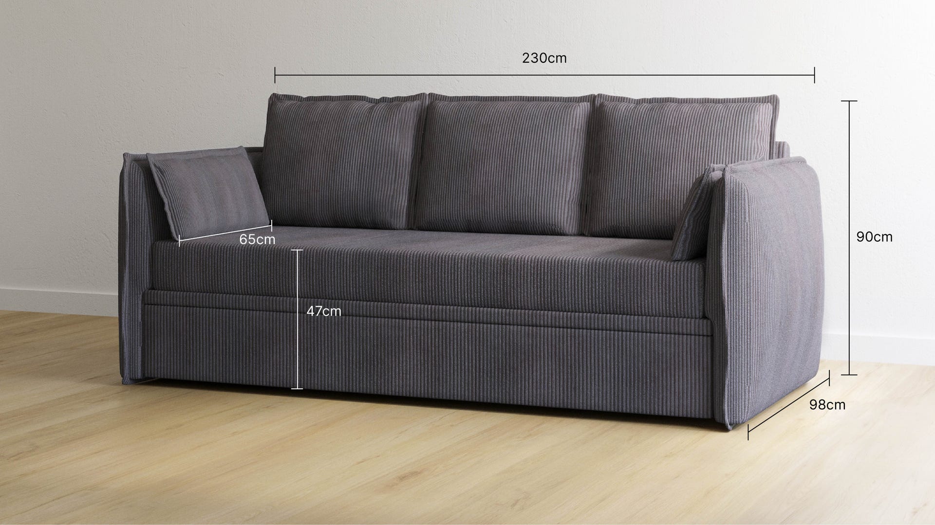 Canapé convertible gris avec trois coussins de dossier et accoudoirs des deux côtés. Dimensions indiquées : largeur 230 cm, hauteur 90 cm, profondeur 98 cm, hauteur d’assise 47 cm, profondeur du coussin d’assise 65 cm. Placé dans un salon lumineux avec mur blanc, buffet en bois, vase décoratif et plante. Ambiance épurée et fonctionnelle.