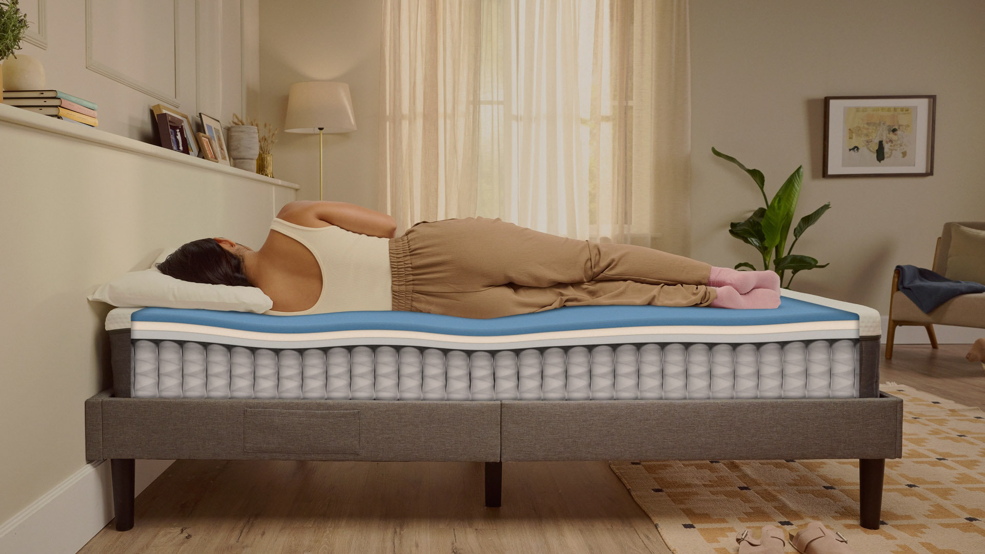 Person lying on their side on a white mattress in a relaxed sleeping position.