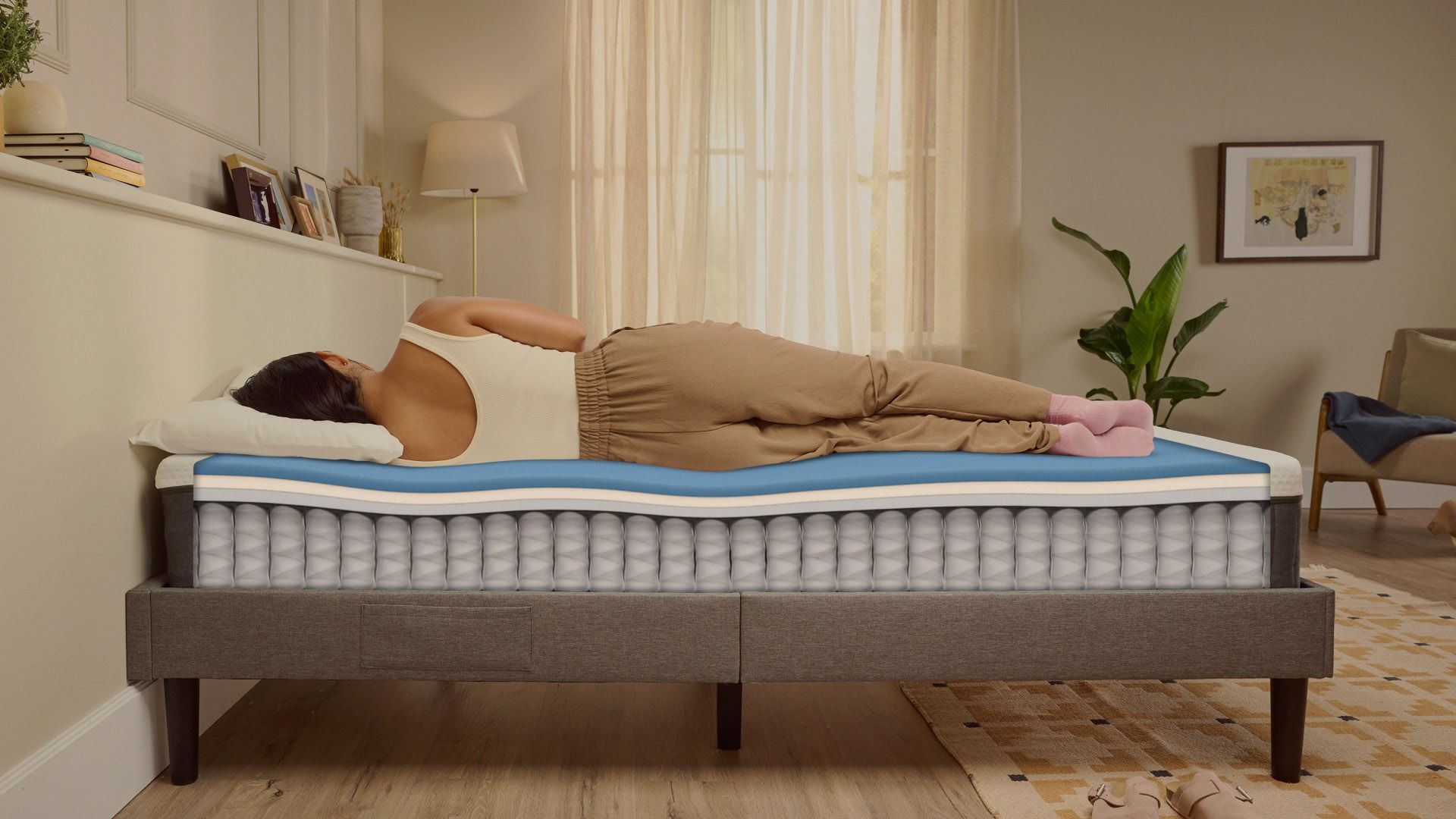 Person lying on their side on a white mattress in a relaxed sleeping position.