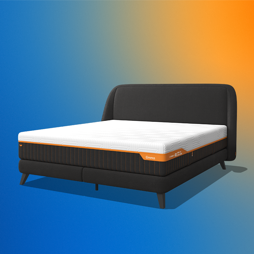 Angled studio render of the dark grey Emma Performance box spring bed with its mattress and tall curved headboard