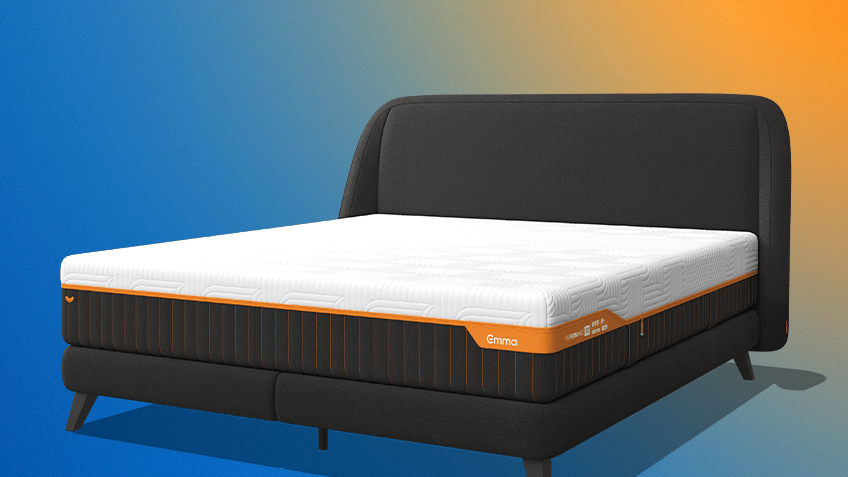 Angled studio render of the dark grey Emma Performance box spring bed with its mattress and tall curved headboard