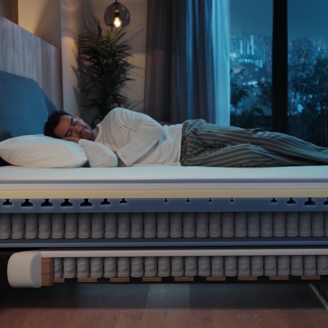 Cutaway of Emma Performance boxspringbed showing sleeper above pocket-spring mattress and spring base with layered support.