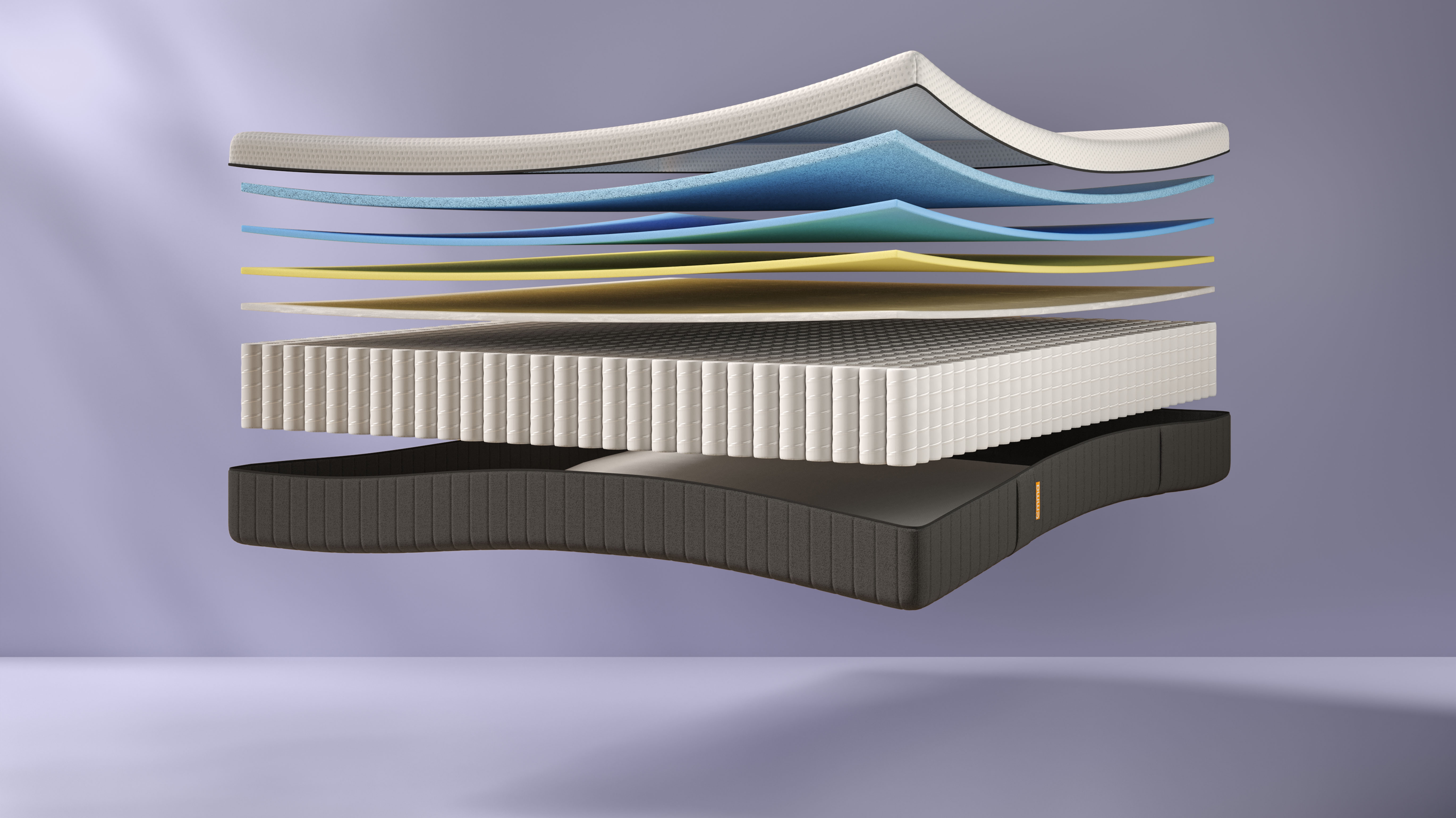 Doorsnede van Emma Hybrid Premium matras met meerdere lagen schuim en metalen pocketveren; lagen gescheiden en zwevend weergegeven tegen witte achtergrond, met zichtbaar contrast tussen zachte bovenlaag en ondersteunende onderlagen.