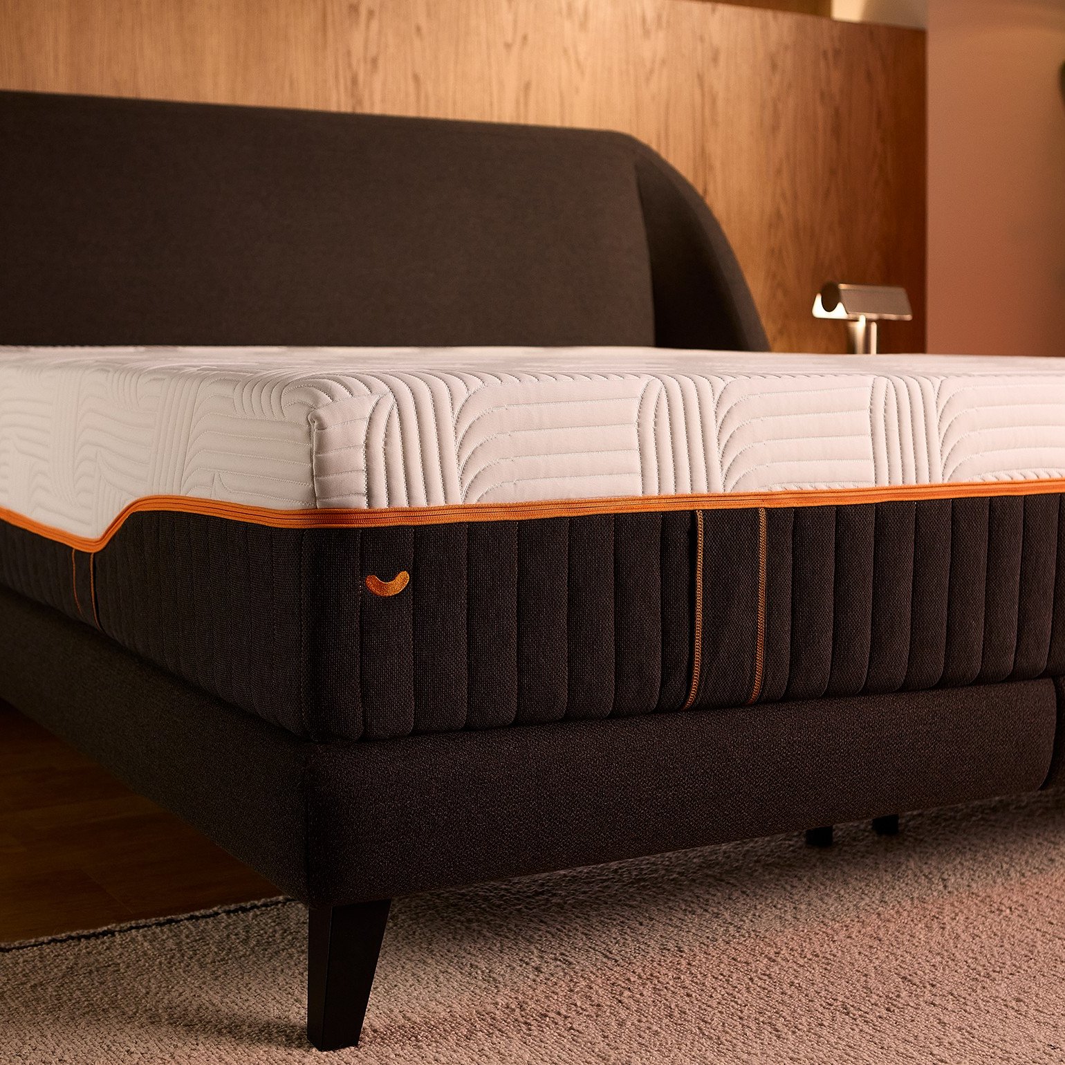 Corner view of the Emma Performance boxspringbed and mattress on slim tapered black legs, with extra central support.