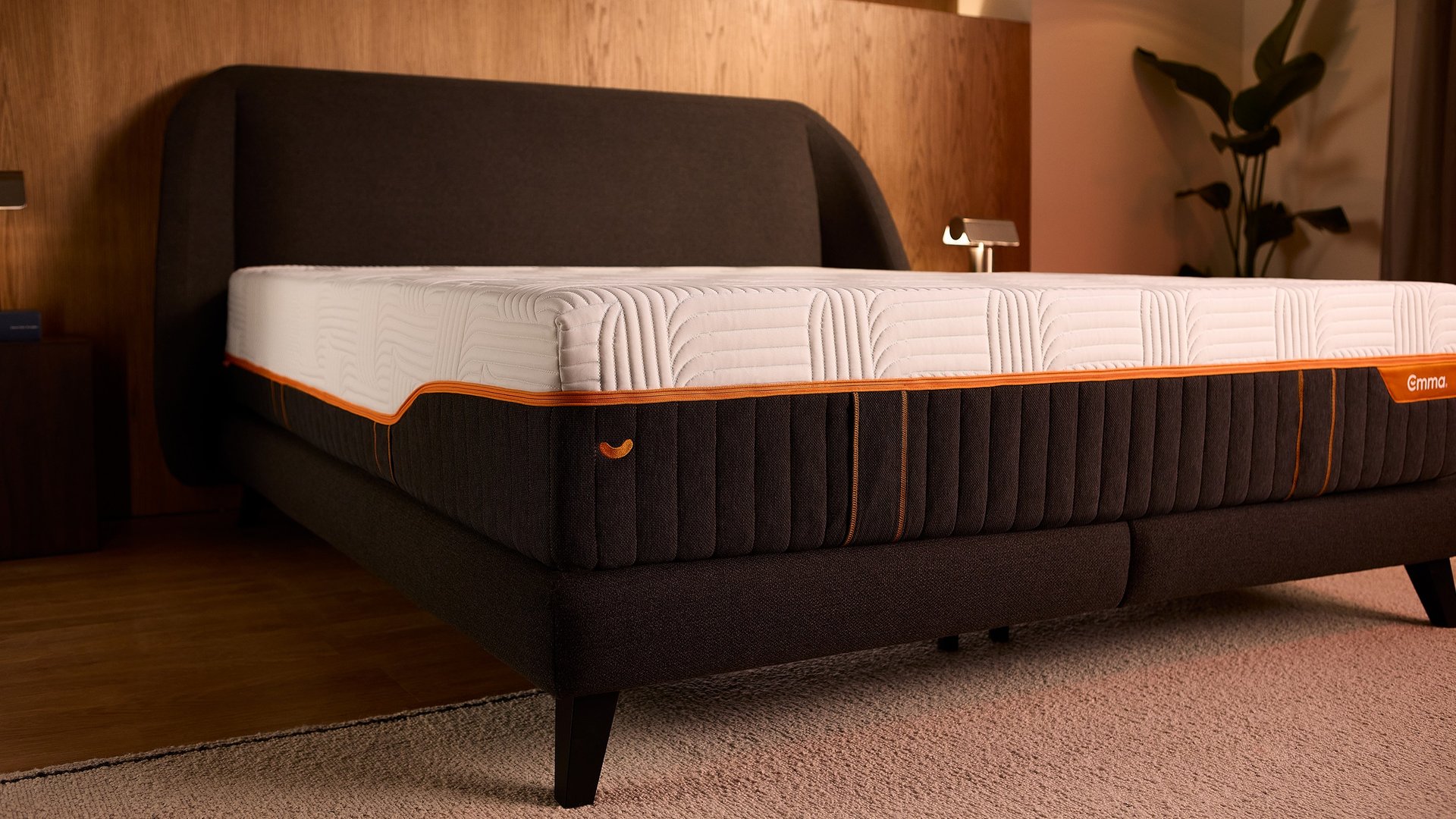 Corner view of the Emma Performance boxspringbed and mattress on slim tapered black legs, with extra central support.