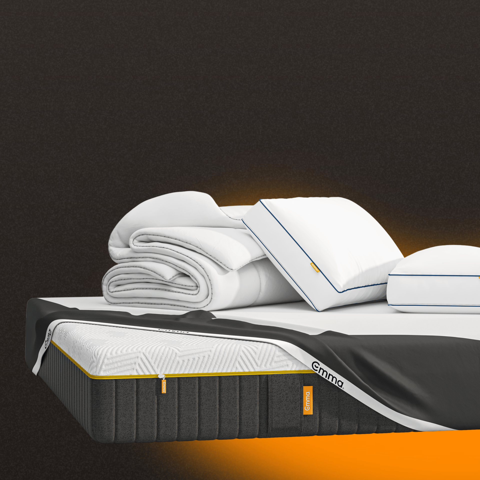A mattress, pillows and protector on a dark background.