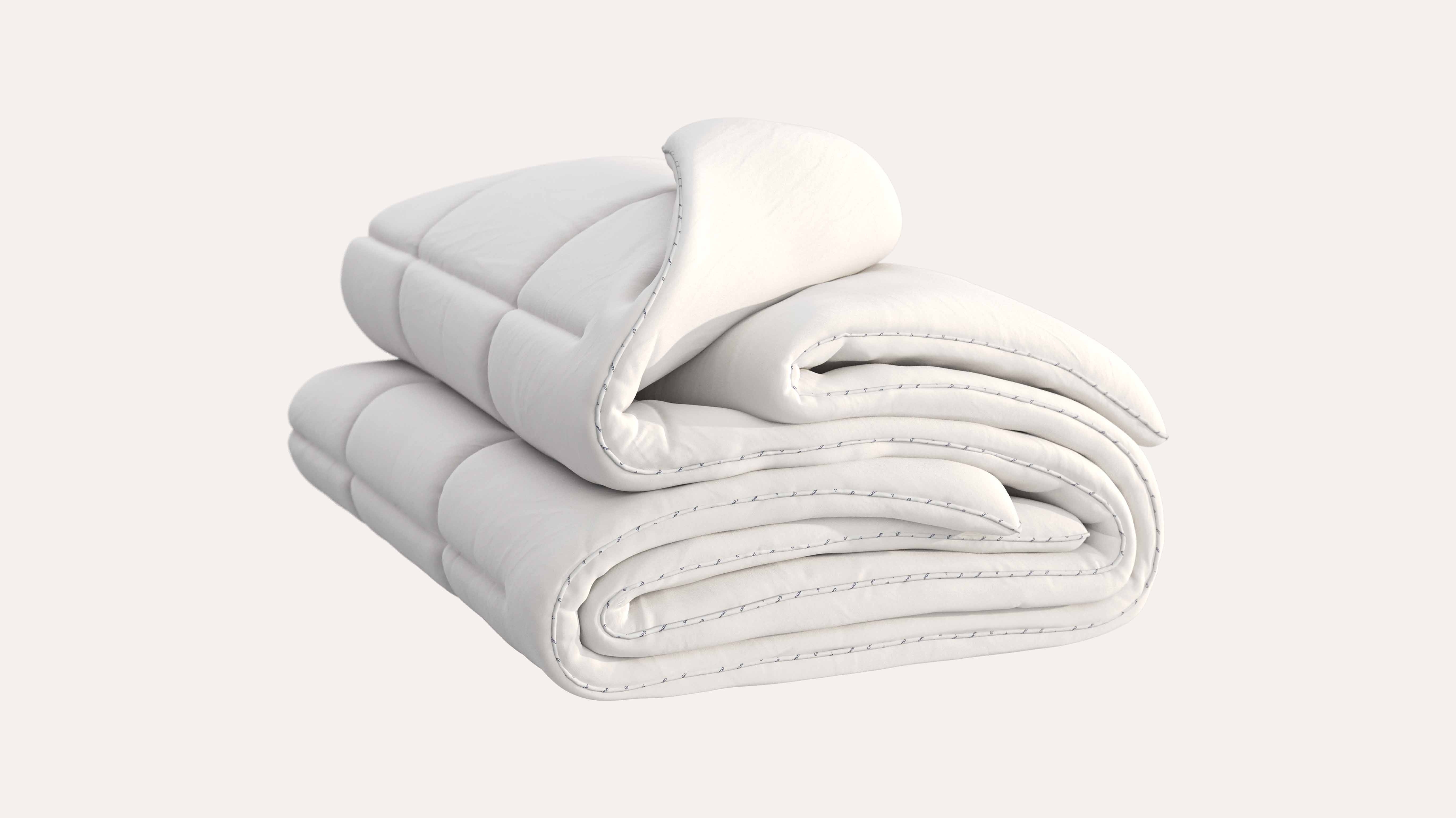 Piumone bianco piegato con cuciture visibili lungo i bordi.