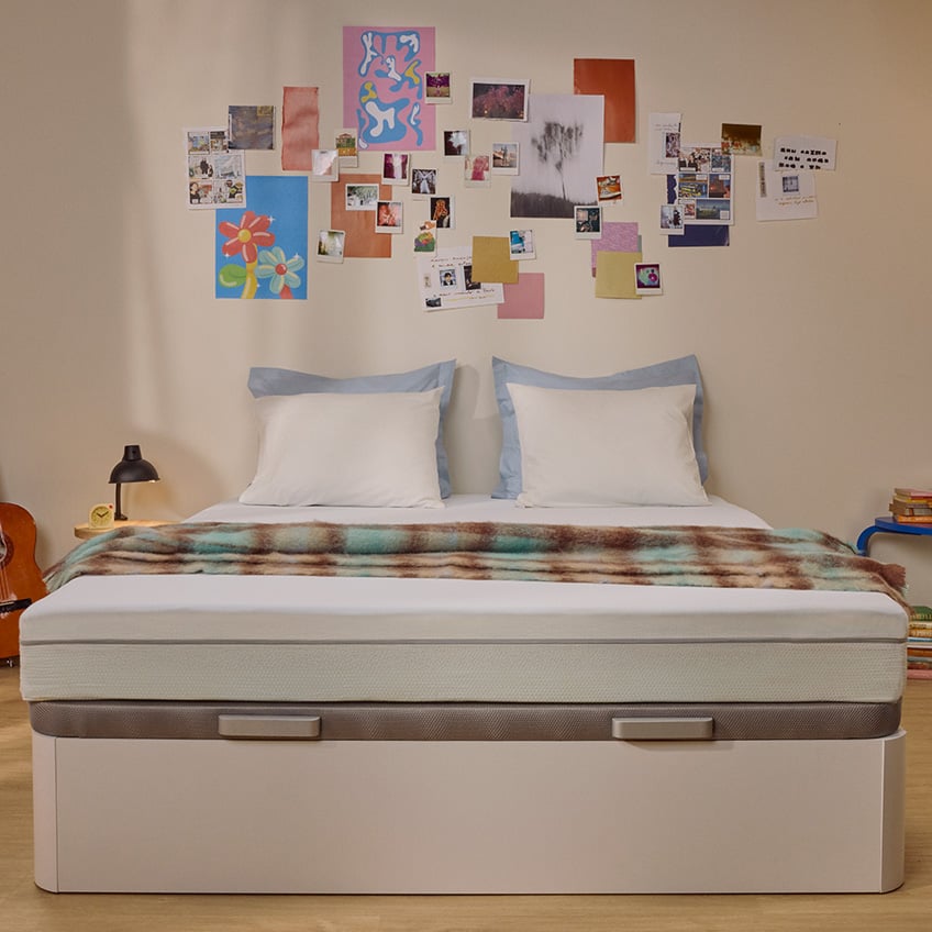 White Emma mattress on an upholstered bed.