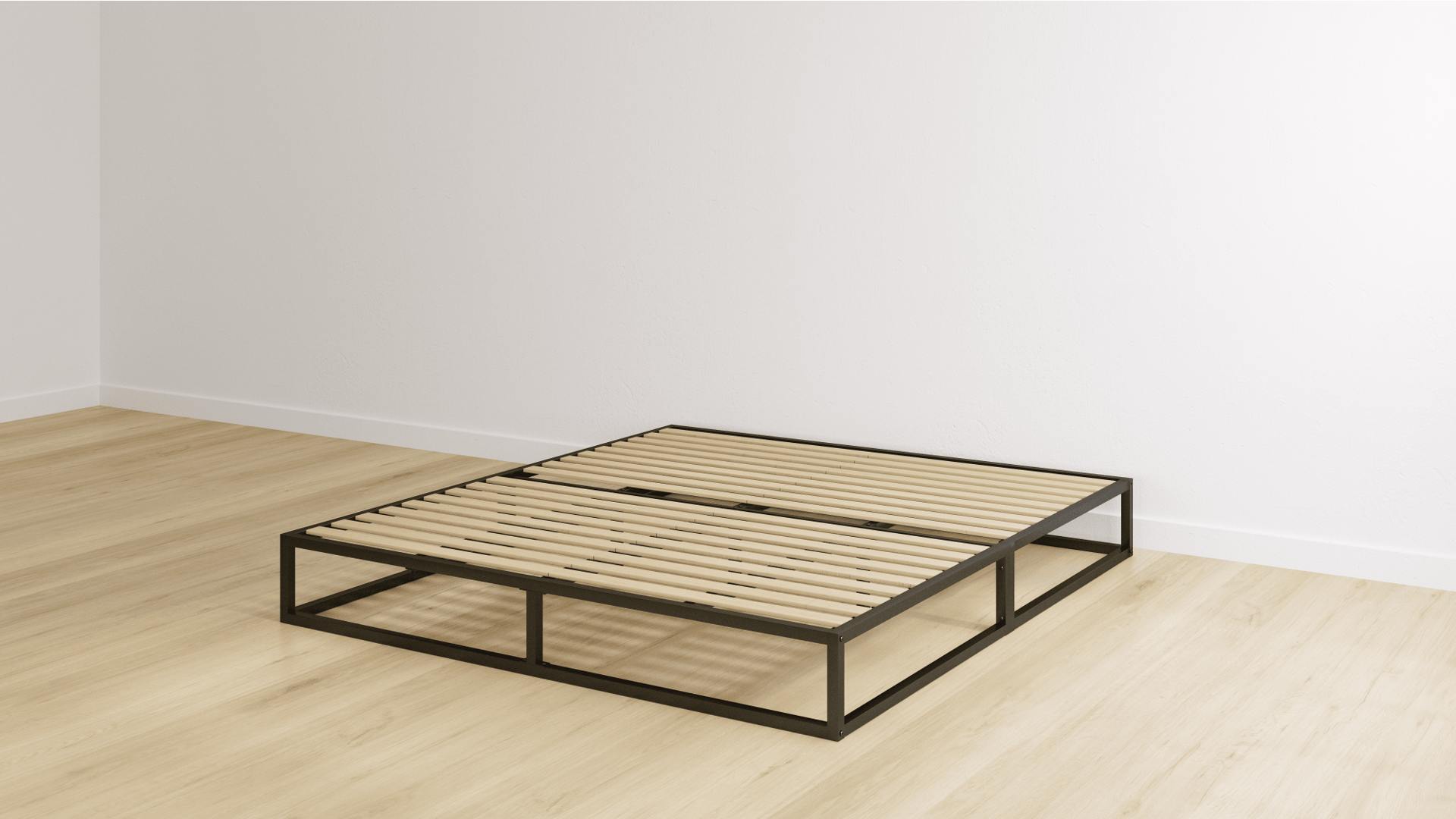 Double bed with metal frame a metal headboard with pillows and wooden slats on a light wooden floor in an empty room.