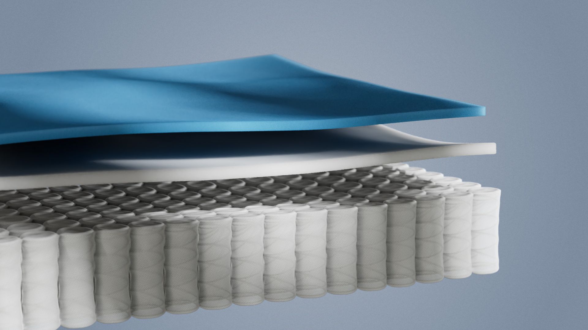 Coupe détaillée d’un matelas hybride montrant les couches de mousse et les ressorts ensachés pour un soutien ergonomique.