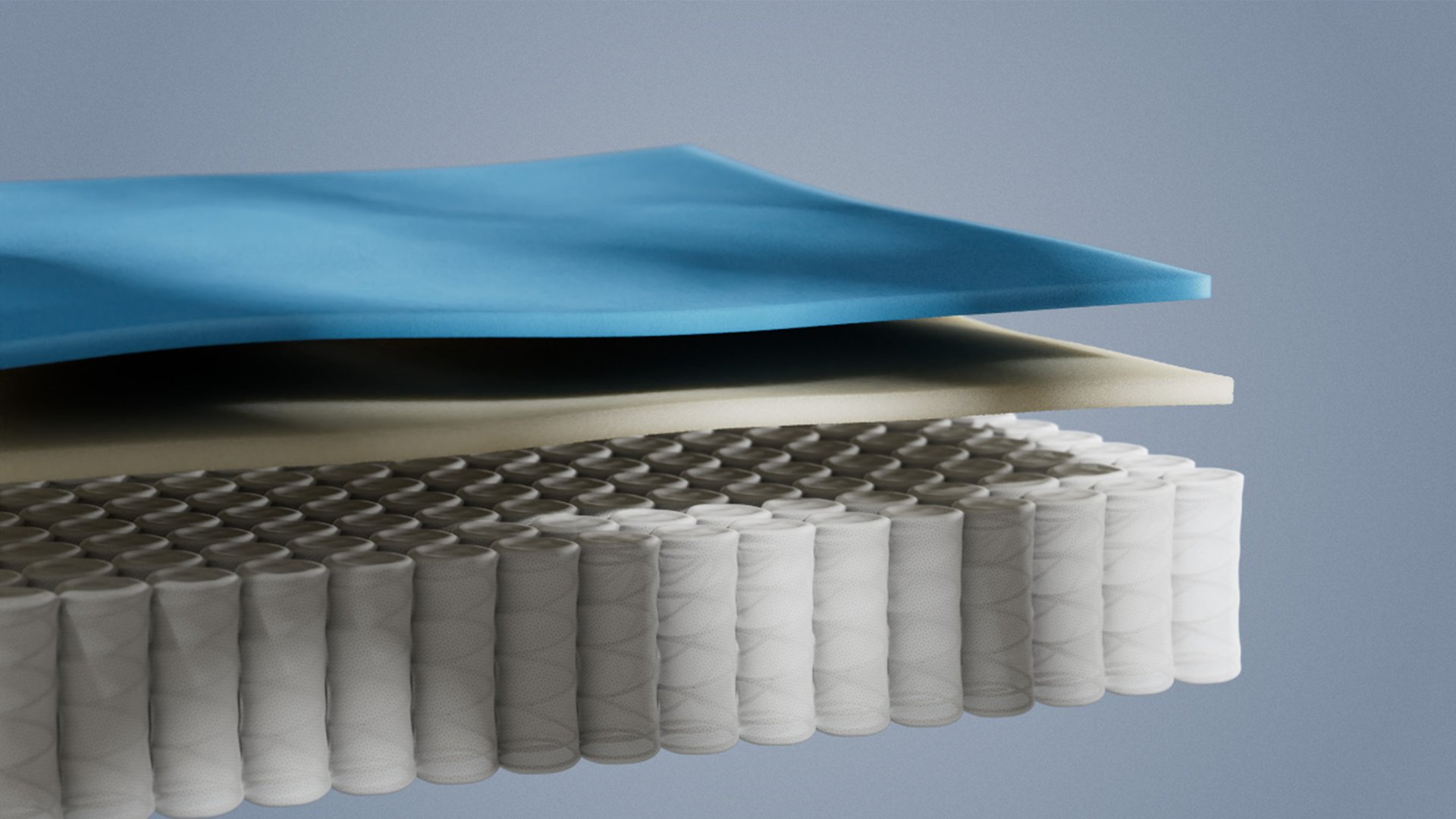 Coupe détaillée d’un matelas hybride montrant les couches de mousse et les ressorts ensachés pour un soutien ergonomique.