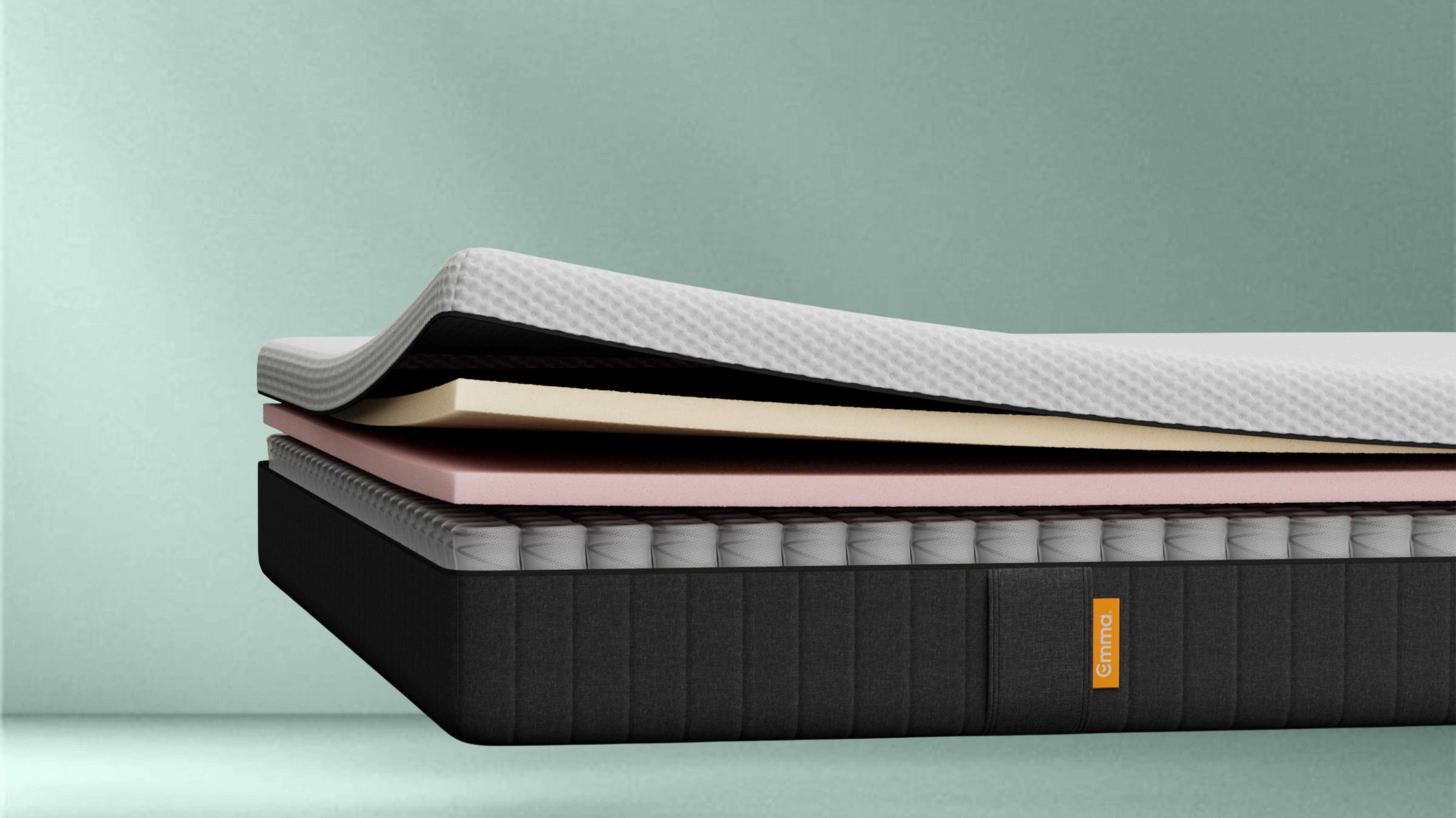 The Emma Original Lite Mattress side view on a green background.