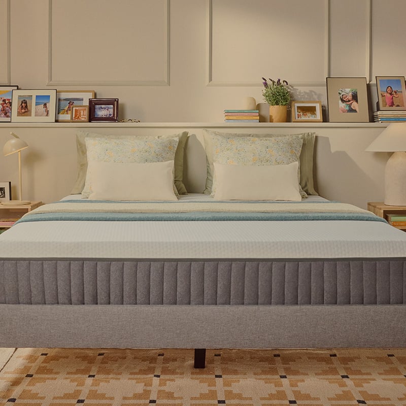 White Emma mattress on an upholstered bed.