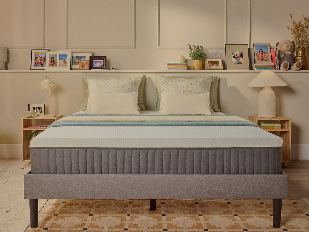 White Emma mattress on an upholstered bed.