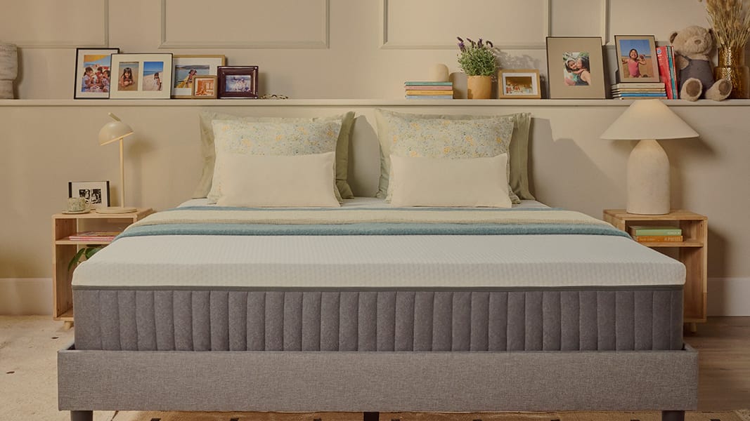 White Emma mattress on an upholstered bed.