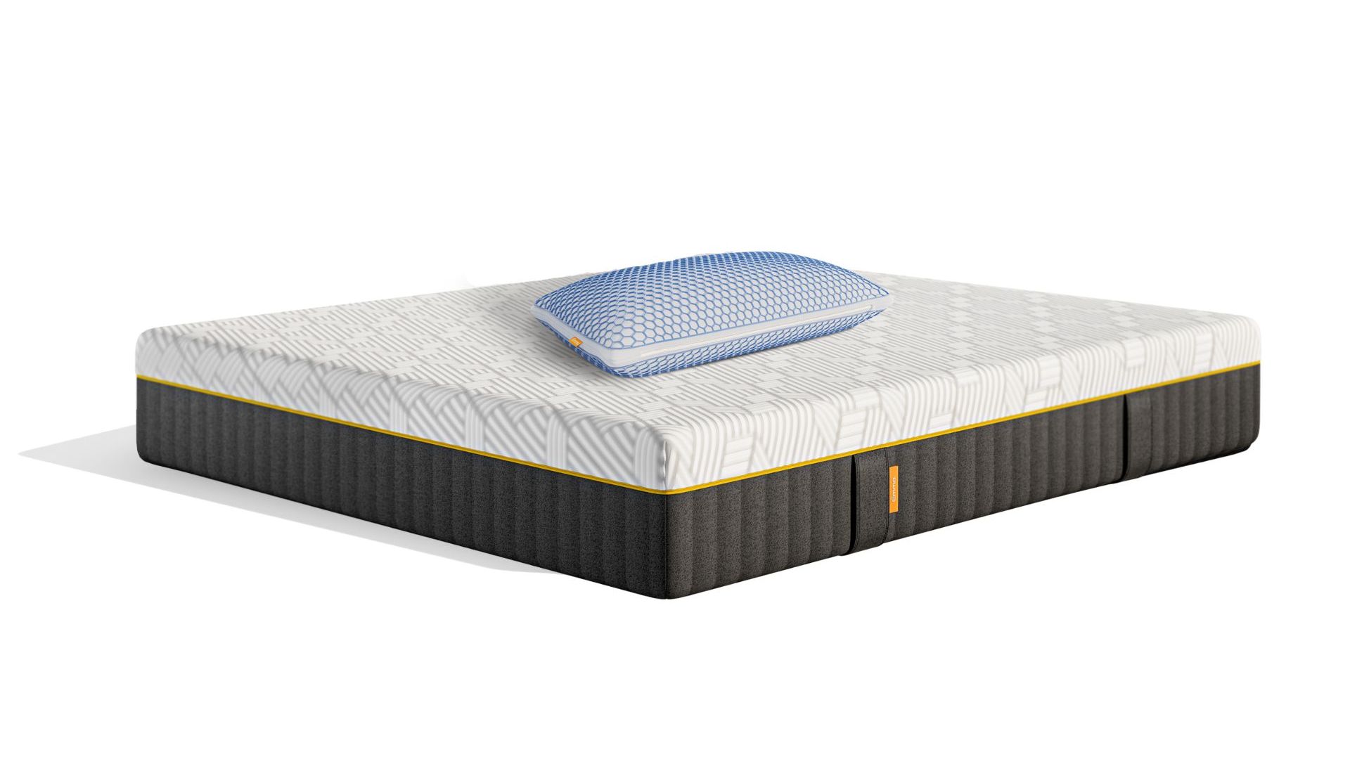 Materasso con copertura bianca e scura con sopra un cuscino