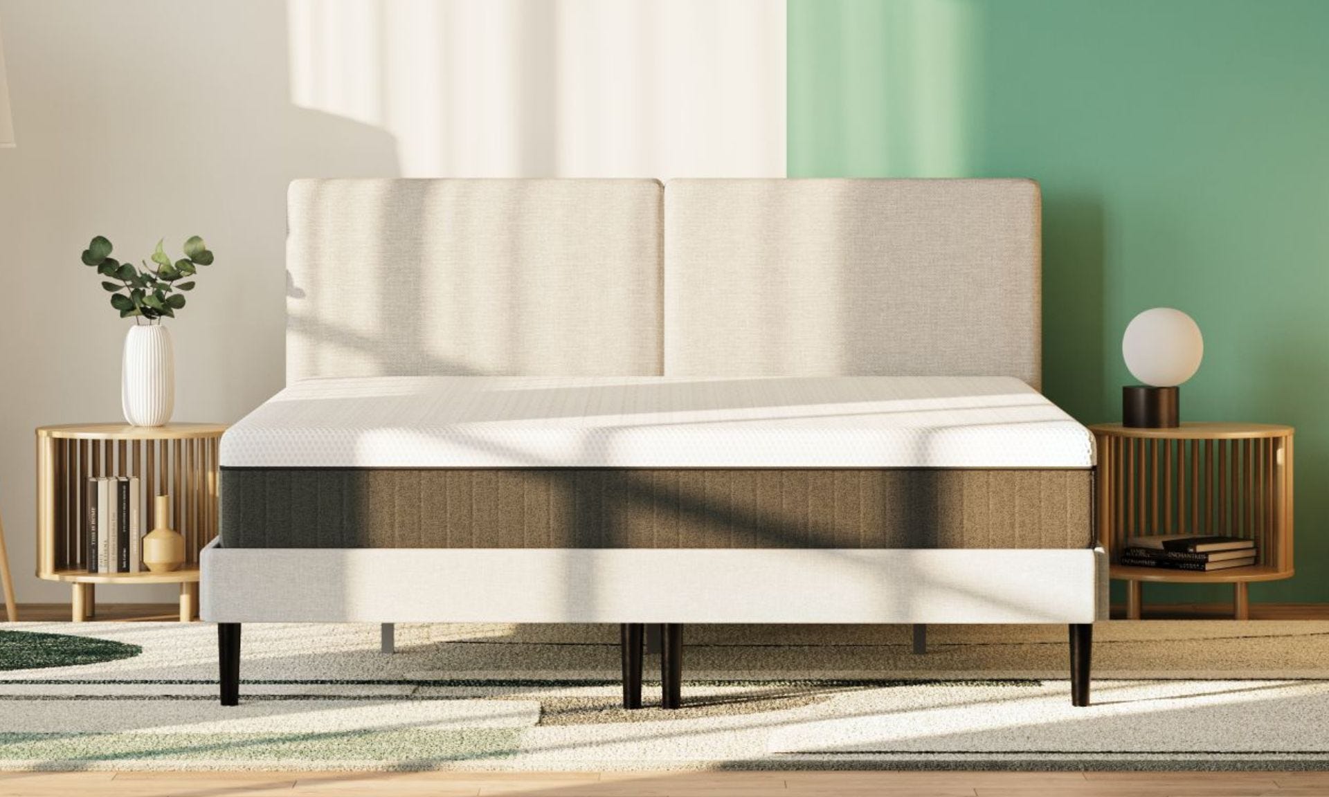 Colchón emma hybrid premium en cama tapizada en dormitorio con paredes verdes y blancas