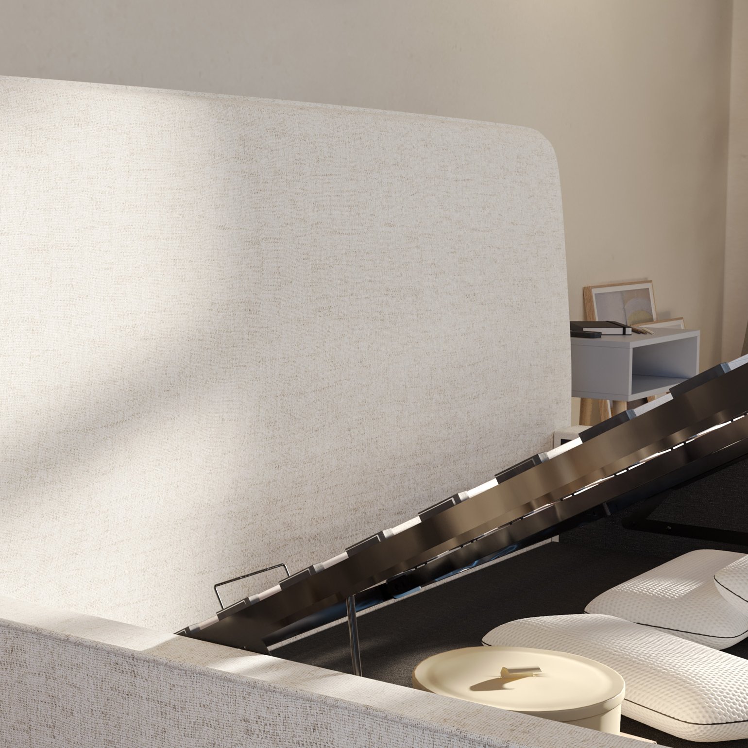 Close-up of Emma storage bed base lifted open, showing the metal lift mechanism and items stored inside.