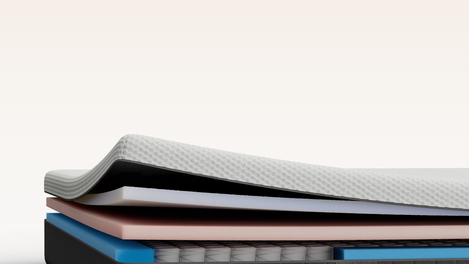 Cross-section of an Emma mattress revealing its layered construction: quilted cover, foam comfort layers, blue base, and pocketed spring core in a dark grey border.