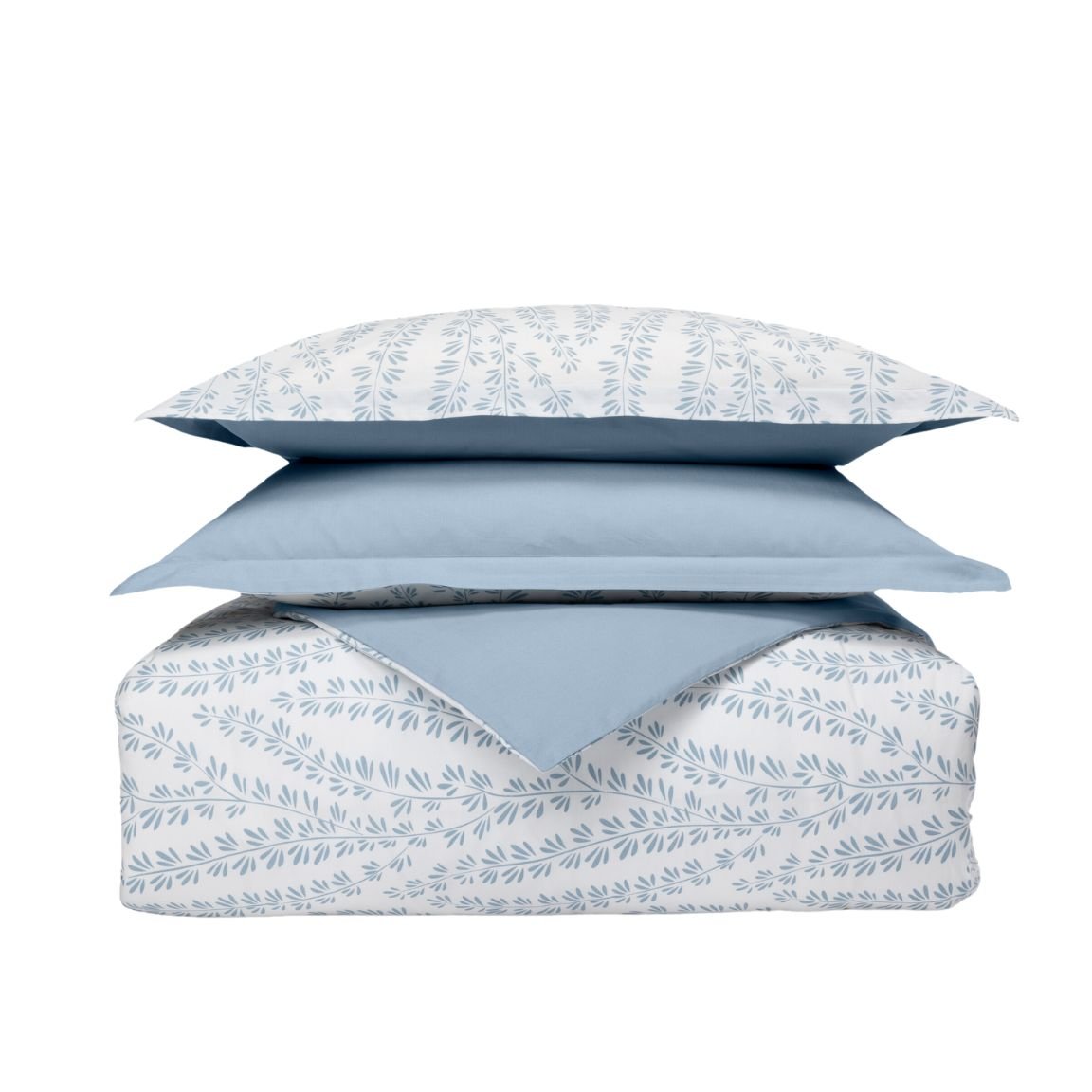Set di biancheria impilato con cuscini e piumone a motivo foglia blu su sfondo bianco e un cuscino azzurro.