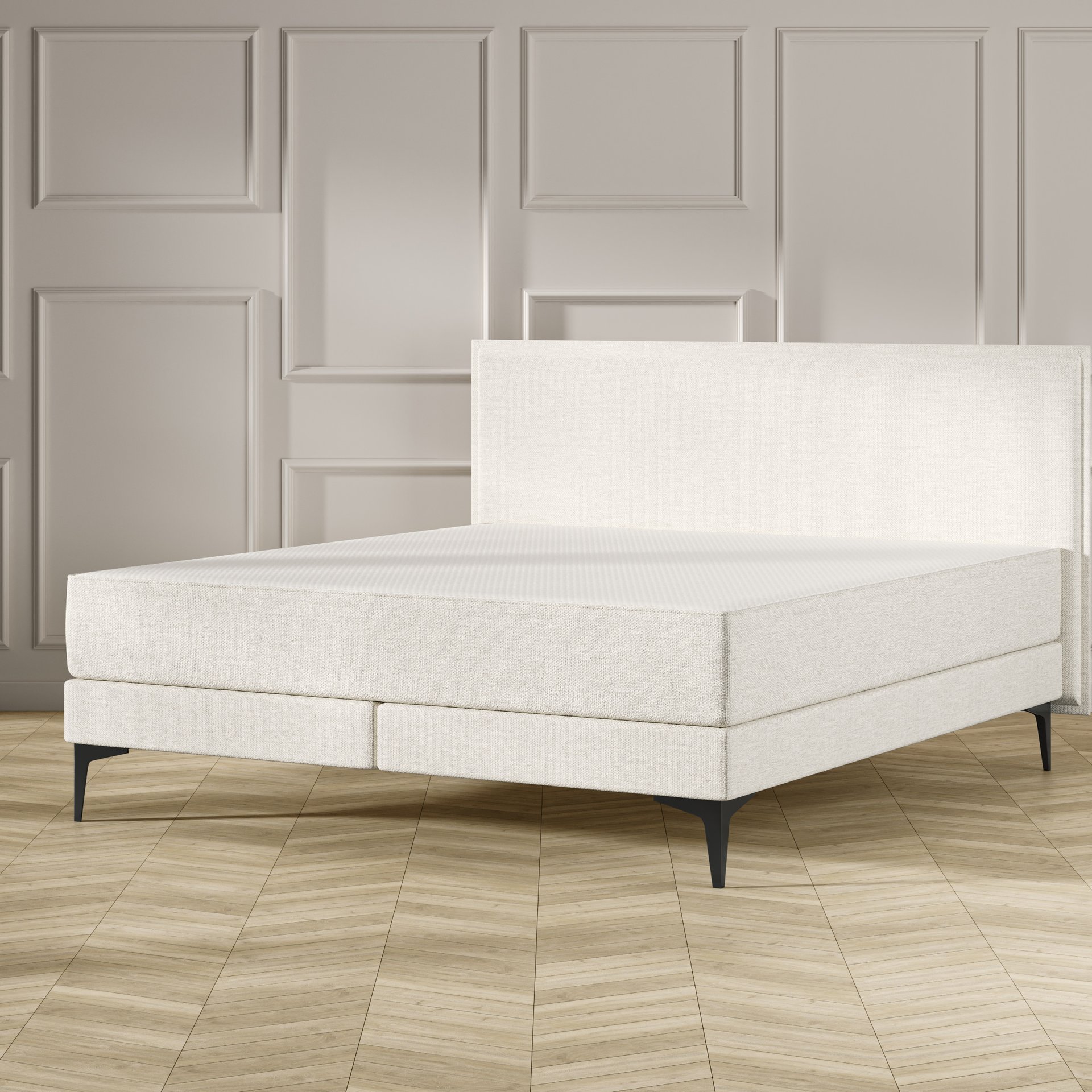 Emma Original Elite Boxspring bed in beige, met effen hoofdbord en metalen pootjes, geplaatst in een stijlvolle slaapkamer met houten vloer.