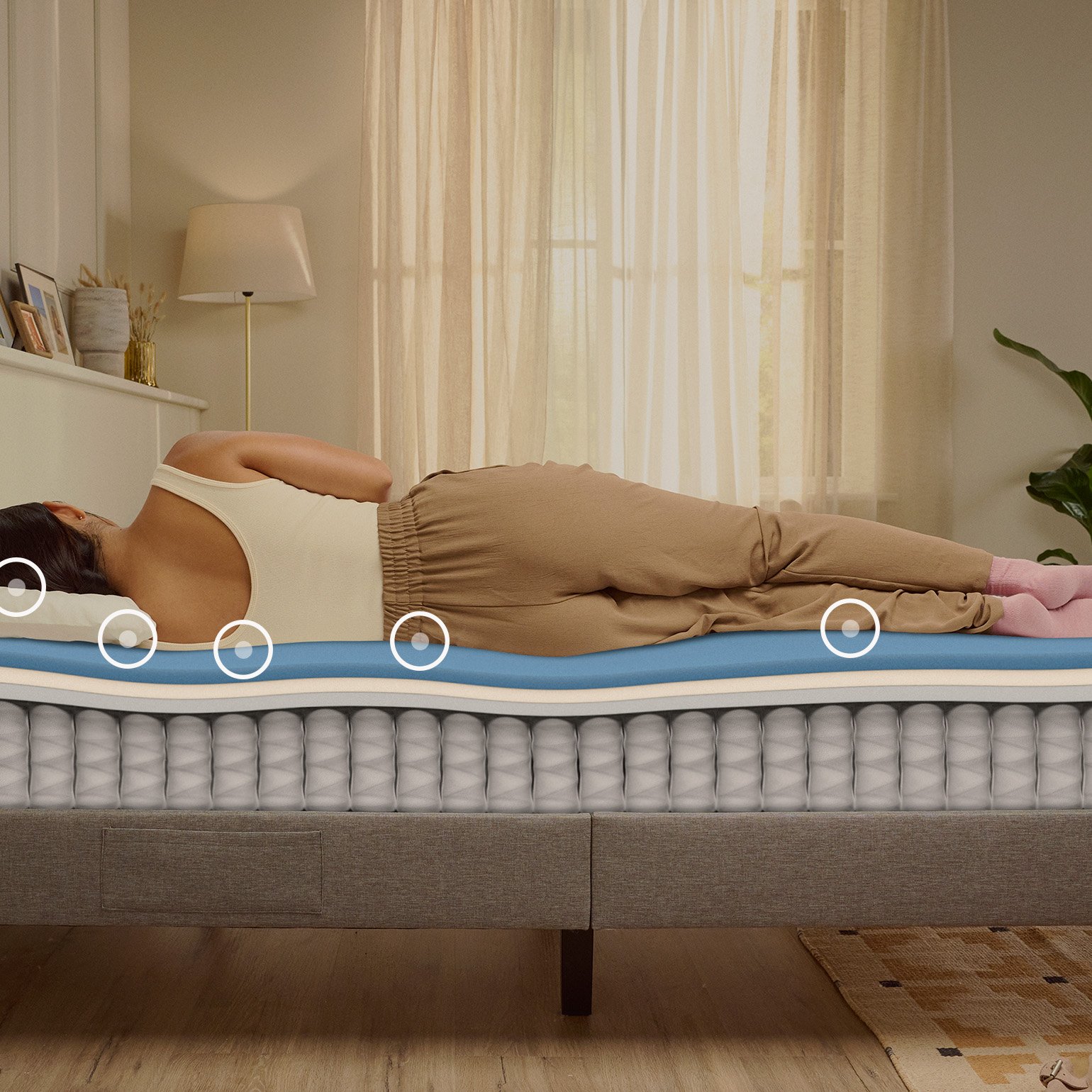 Person lying on their side on a white mattress in a relaxed sleeping position.