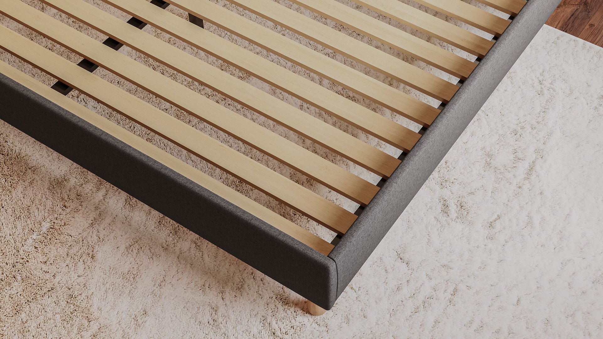 Gros plan du Emma Boxbed beige montrant le sommier à lattes en bois et l’angle du cadre rembourré.