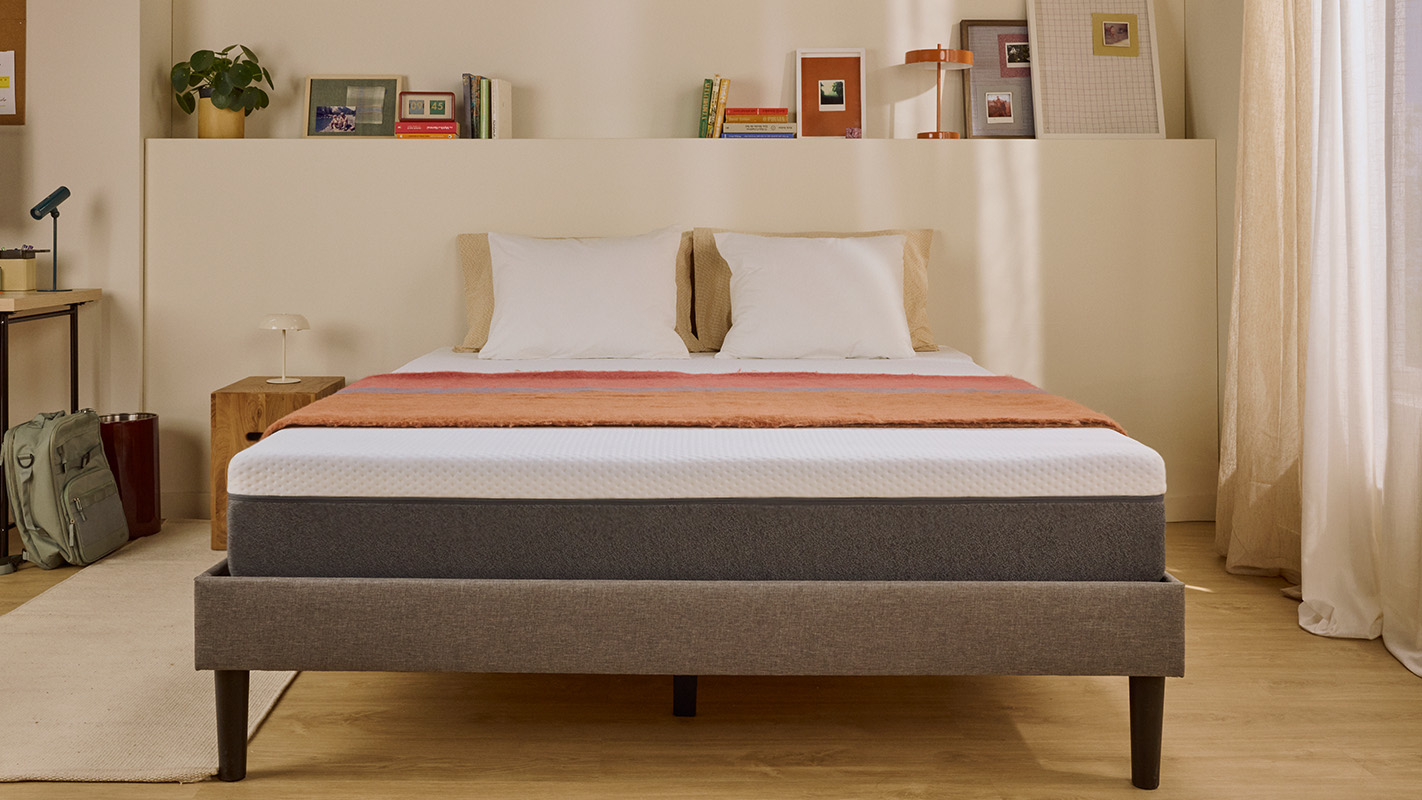 White Emma mattress on an upholstered bed.