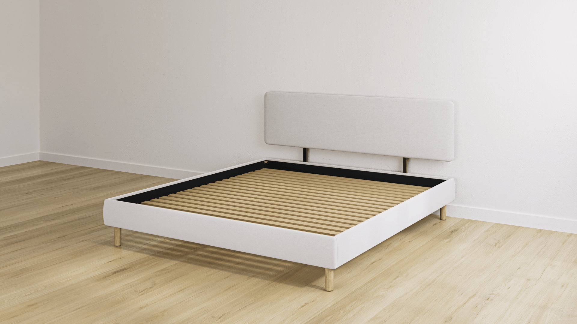 Beige bedframe met een hoofdeinde en een houten lattenbodem in een lege kamer met een lichte houten vloer.