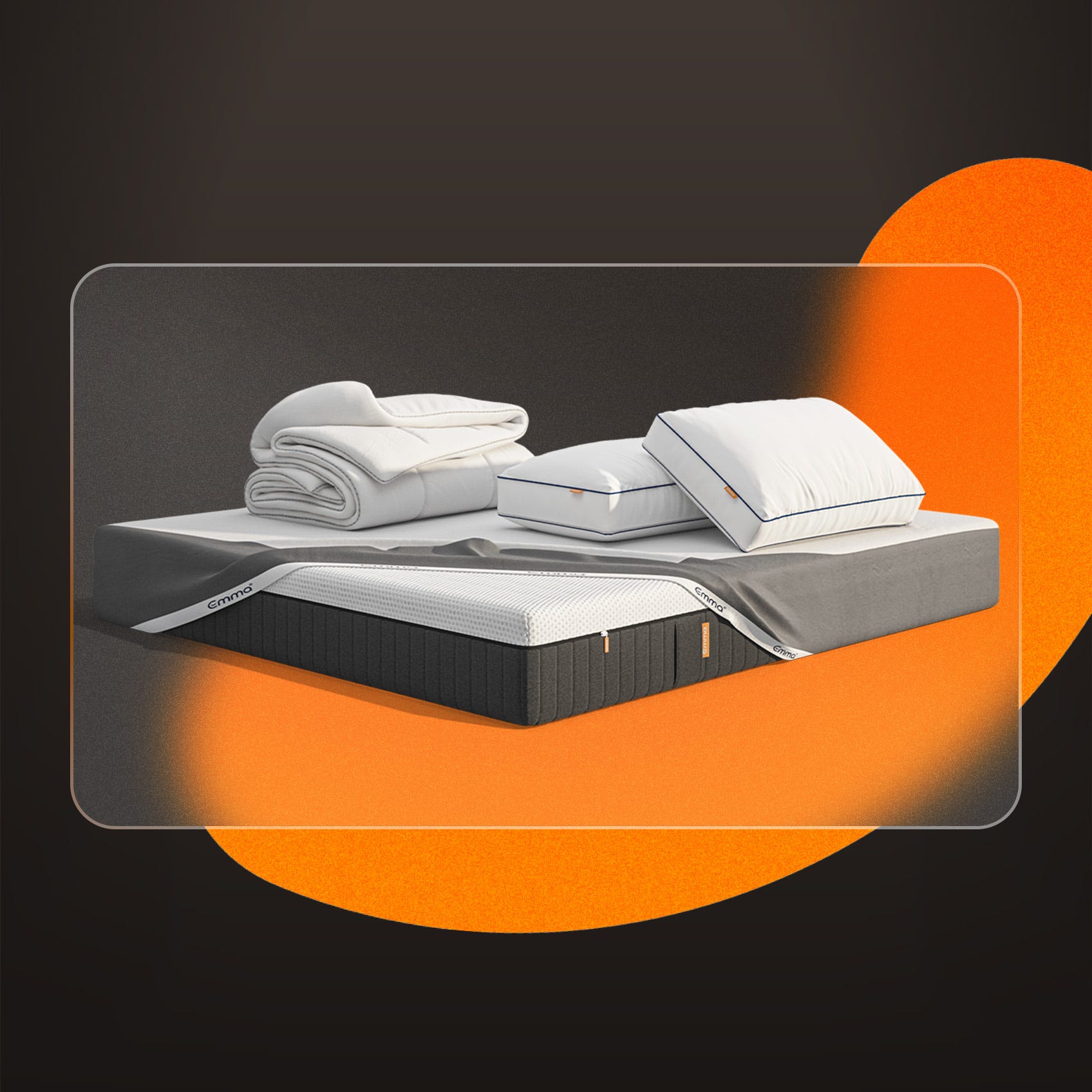 A mattress, pillows, protector and duvet on a dark background.