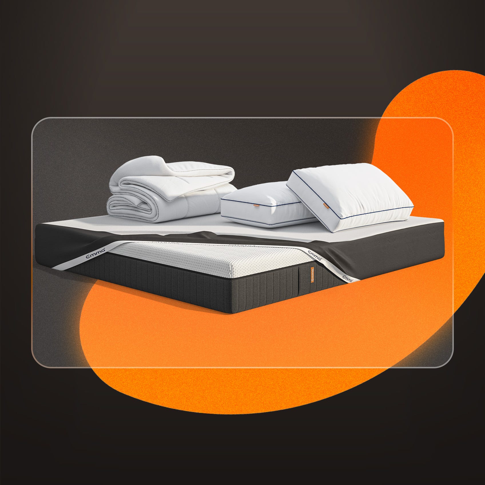 A mattress, pillows, protector and duvet on a dark background.