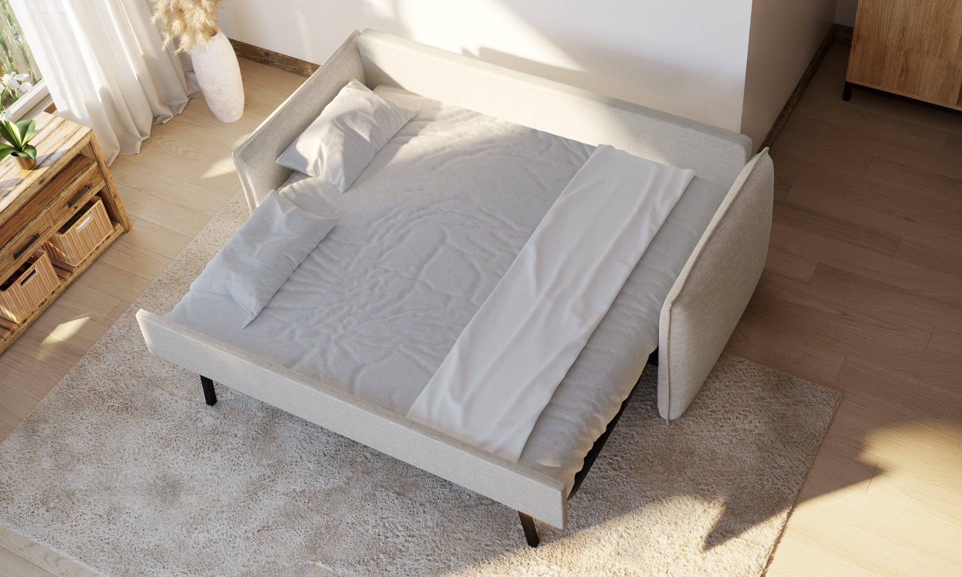 Sofa cama extendido en una cama doble con sábanas
