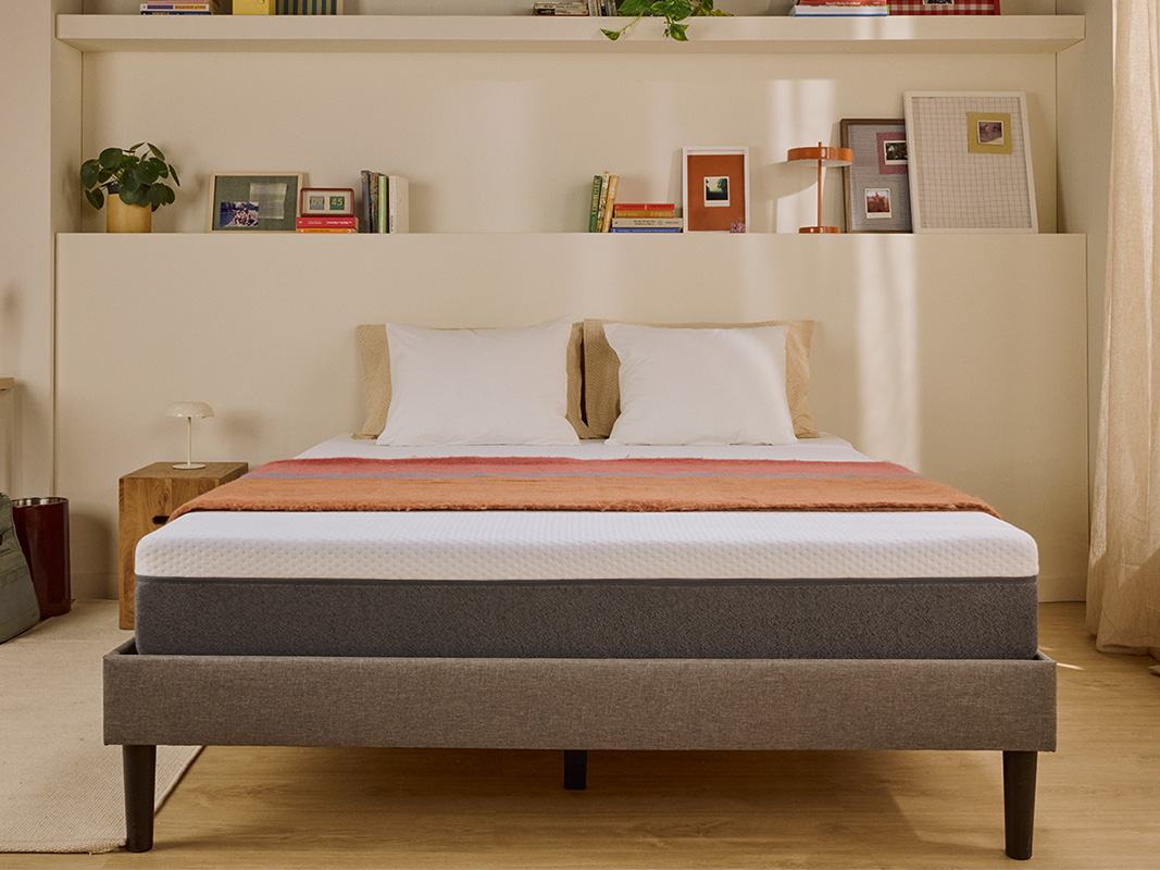 White Emma mattress on an upholstered bed.