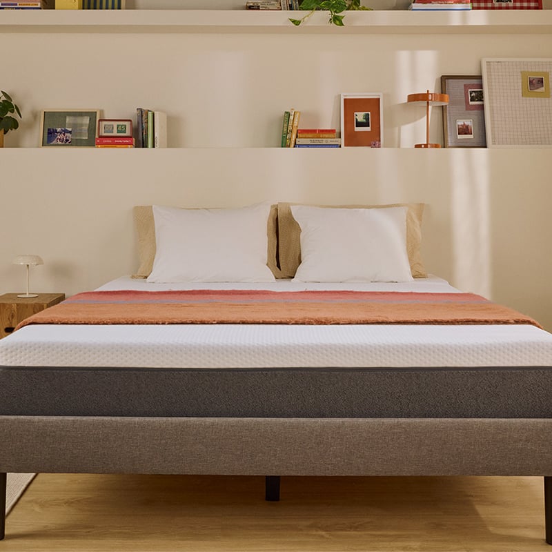 White Emma mattress on an upholstered bed.