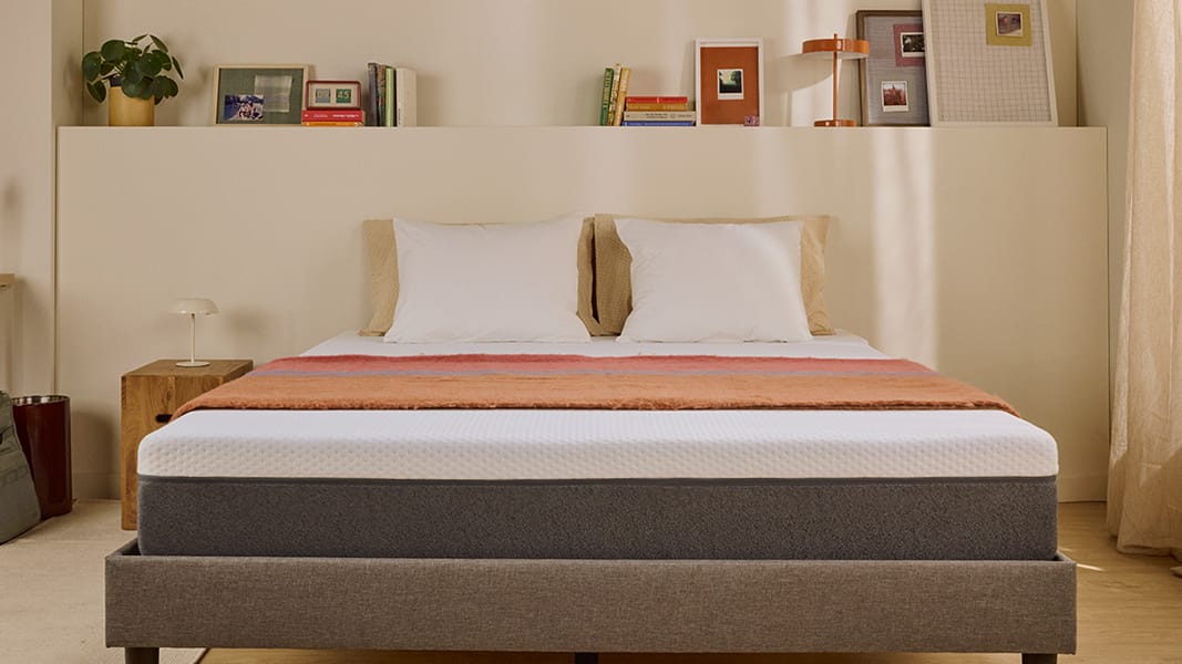 White Emma mattress on an upholstered bed.