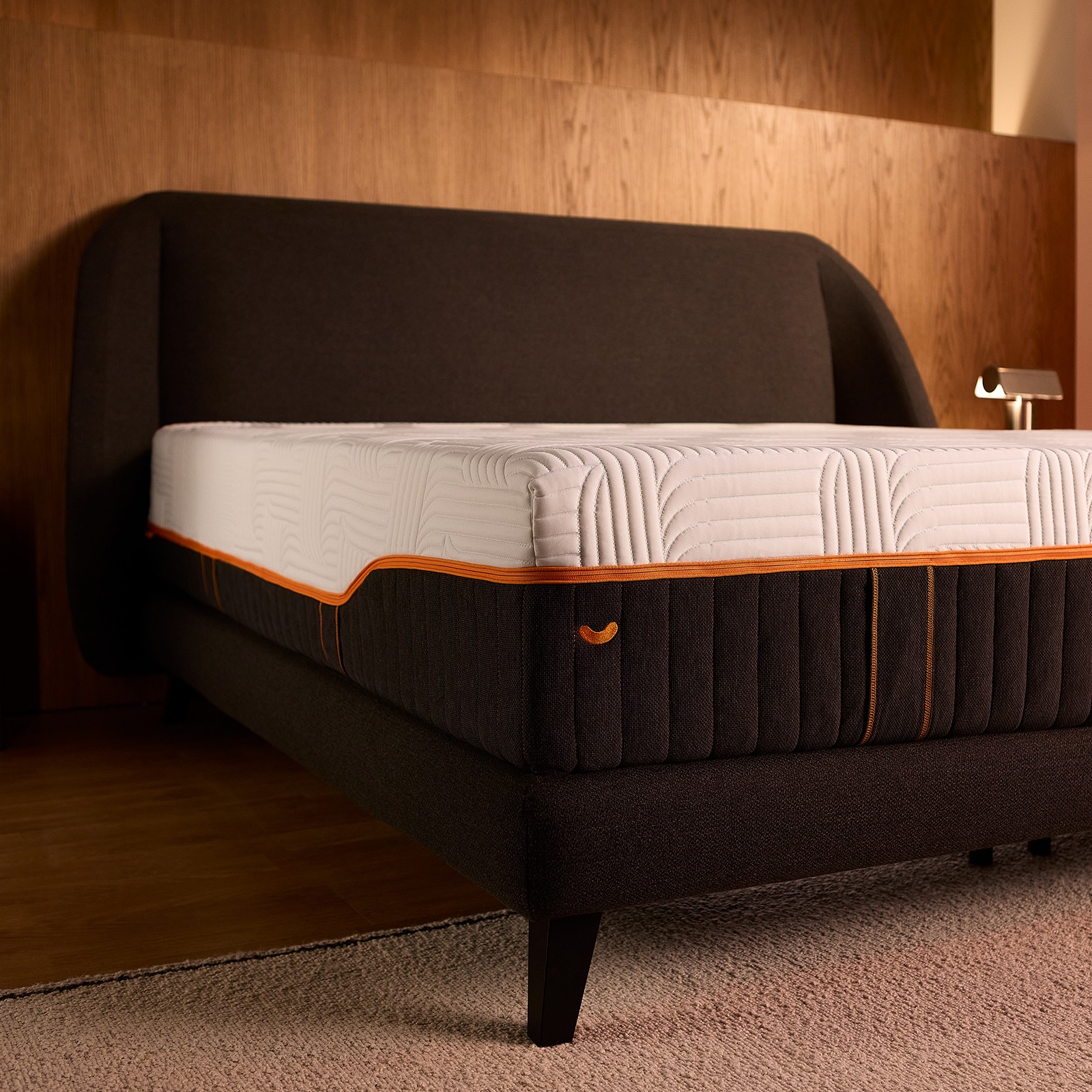 Corner view of the Emma Performance boxspringbed and mattress on slim tapered black legs, with extra central support.