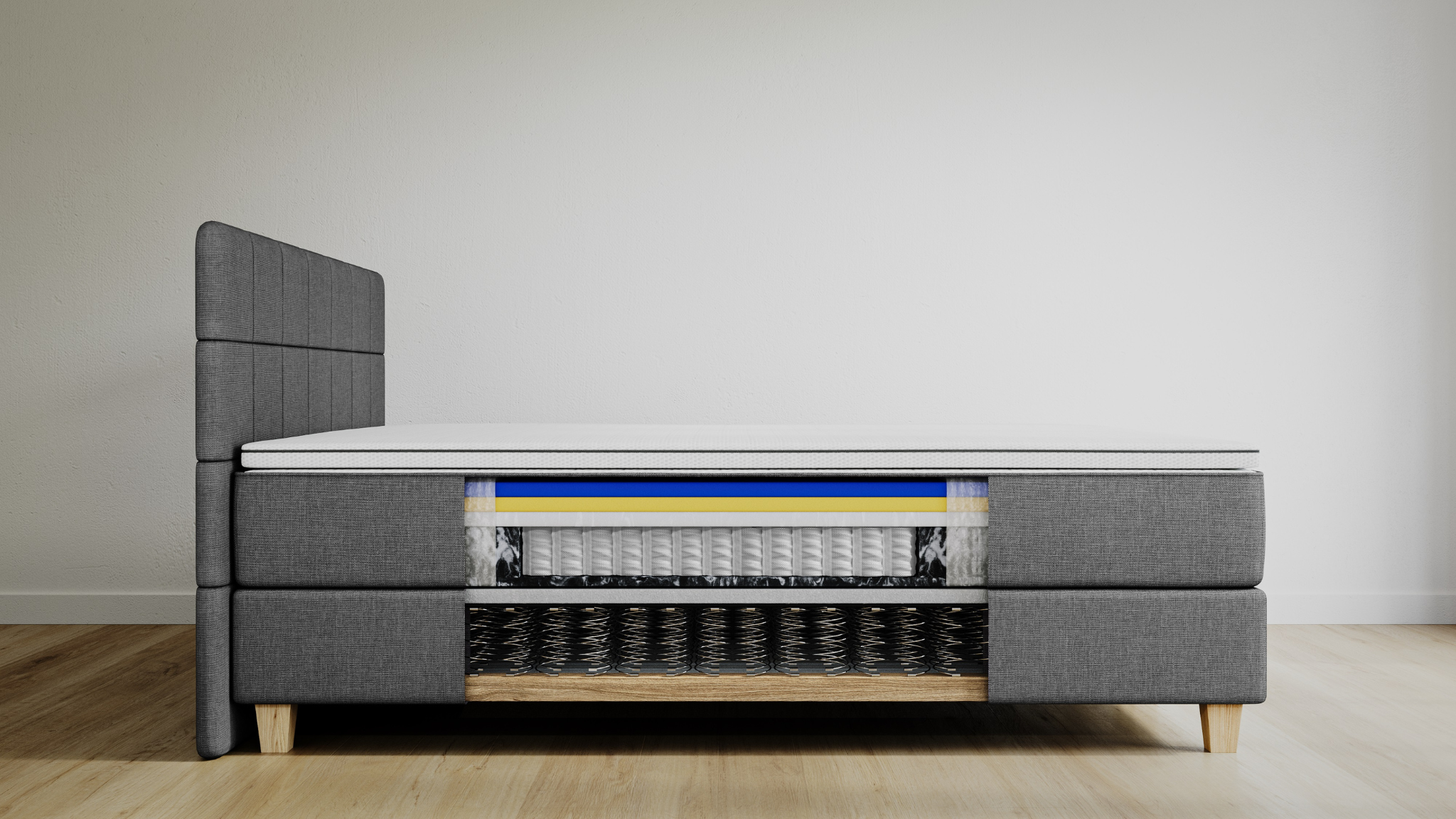 Zijaanzicht van een Emma Deluxe Boxspring met open doorsnede, waarin de lagen van de Emma Hybrid II Matras en Emma Diamond Topper zichtbaar zijn, inclusief schuimlagen en pocketveren. De bedombouw is lichtgrijs met houten poten.