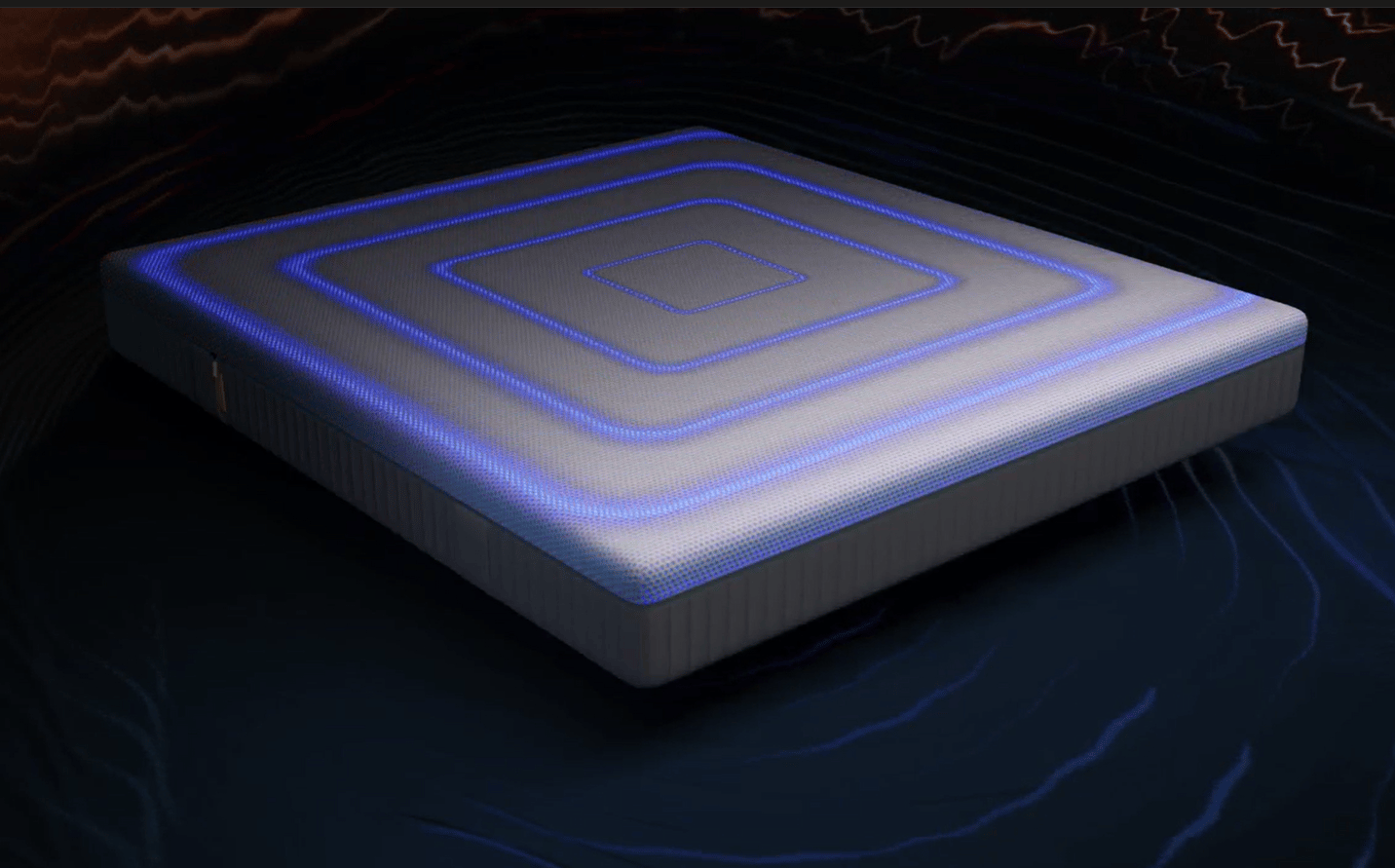 Una mano desliza suavemente sobre el colchón con tecnología AirGrid.