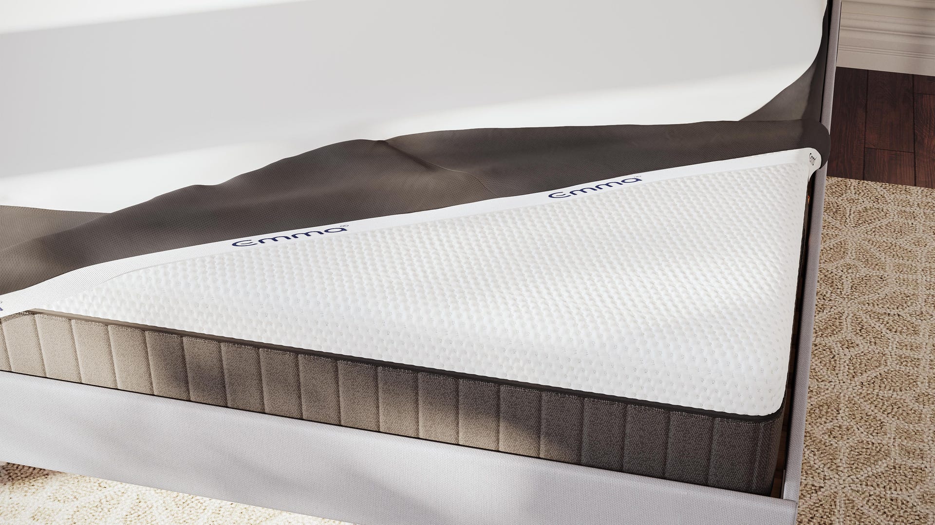 A mattress protector tucked on top of an Emma mattress.