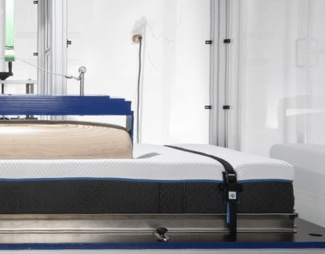 Machine pressing on the mattress