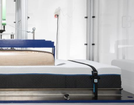Machine pressing on the mattress