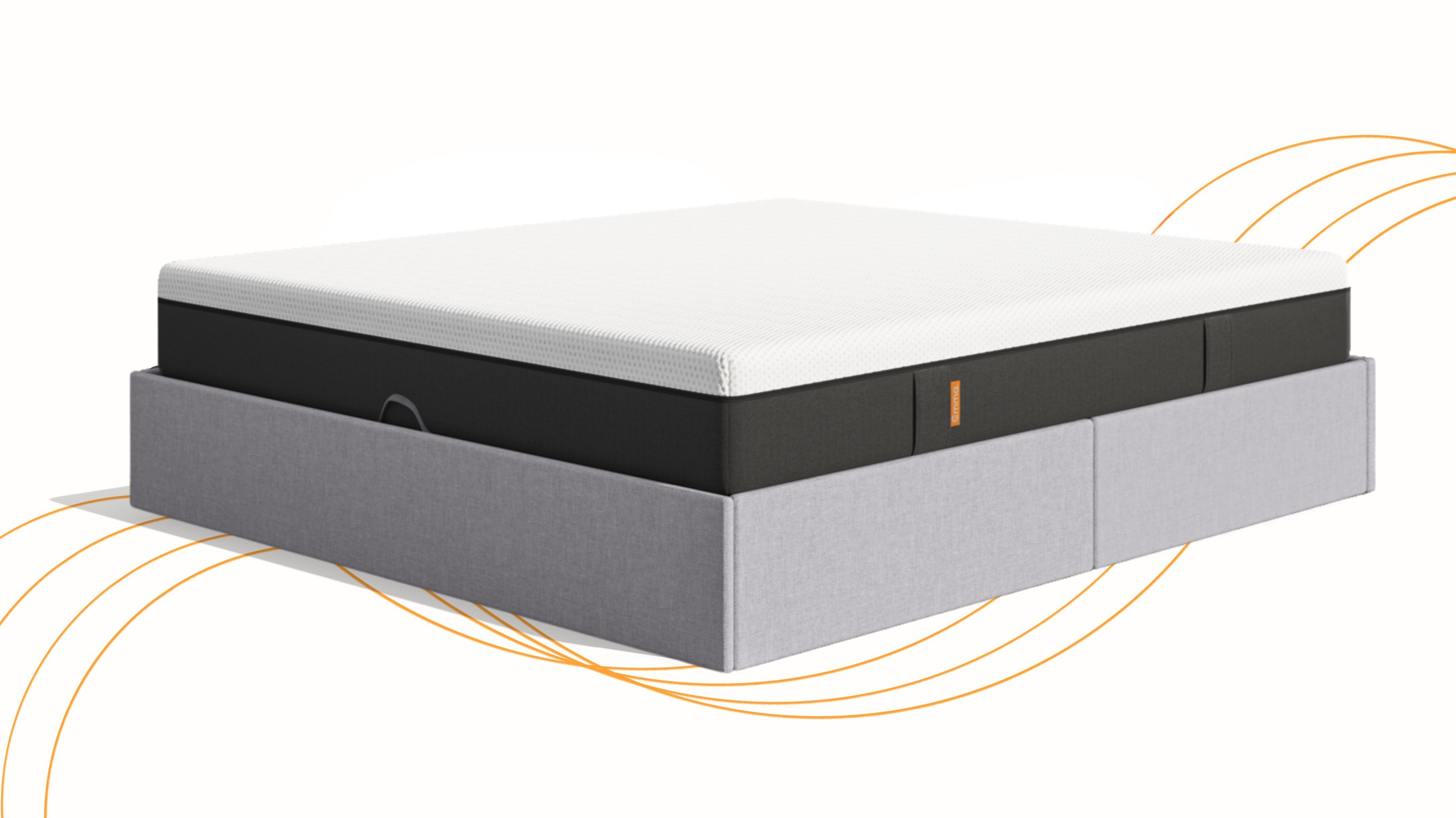 An Emma ottoman storage in a well lit bedroom. The bed has pillows and a duvet on top.