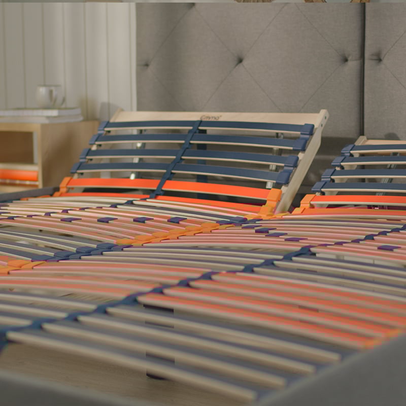 Adjustable slatted bed base with flexible wooden slats.