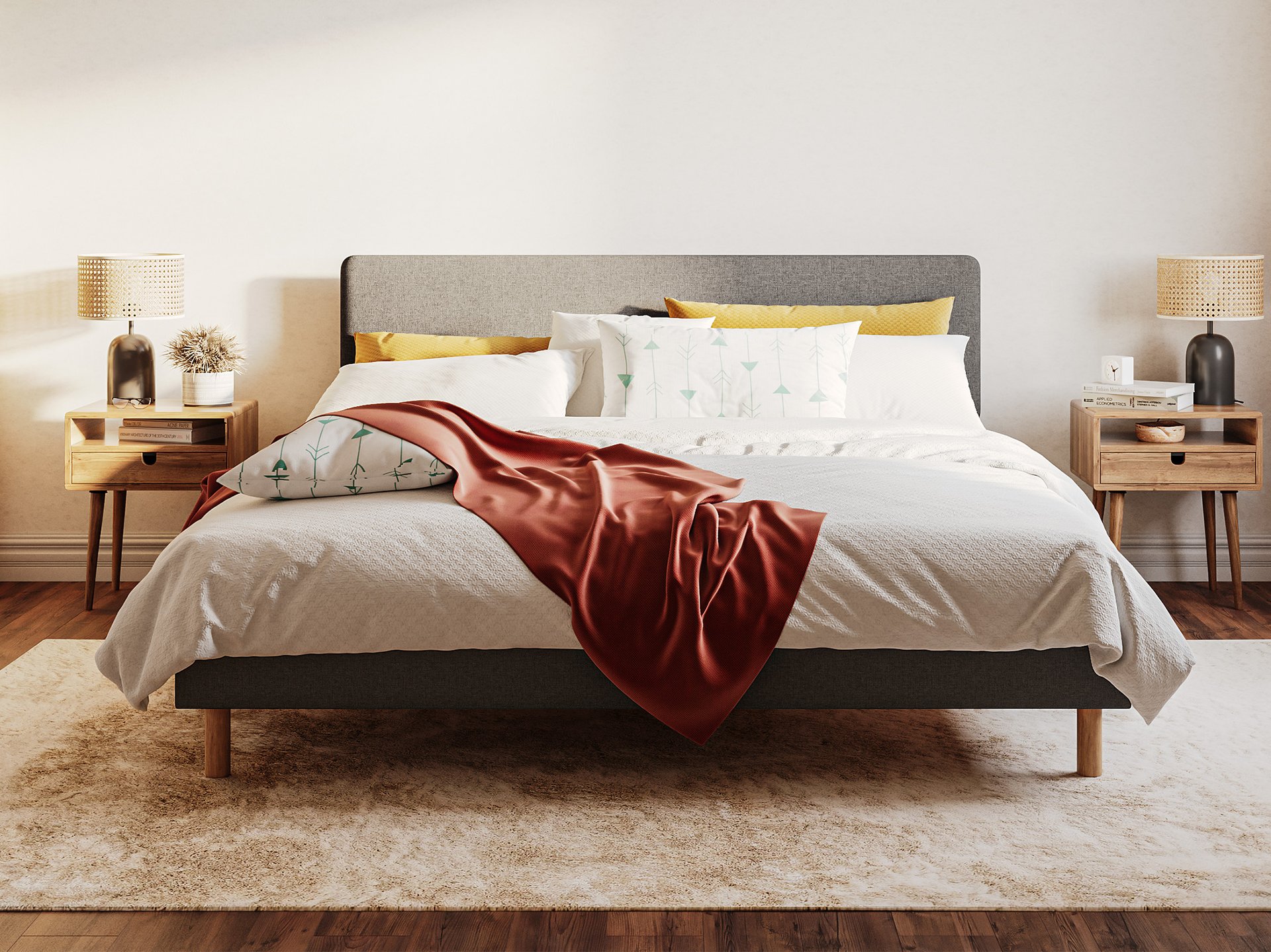 Emma Boxbed in grey with upholstered headboard and wooden legs, styled in a warm Scandinavian bedroom.